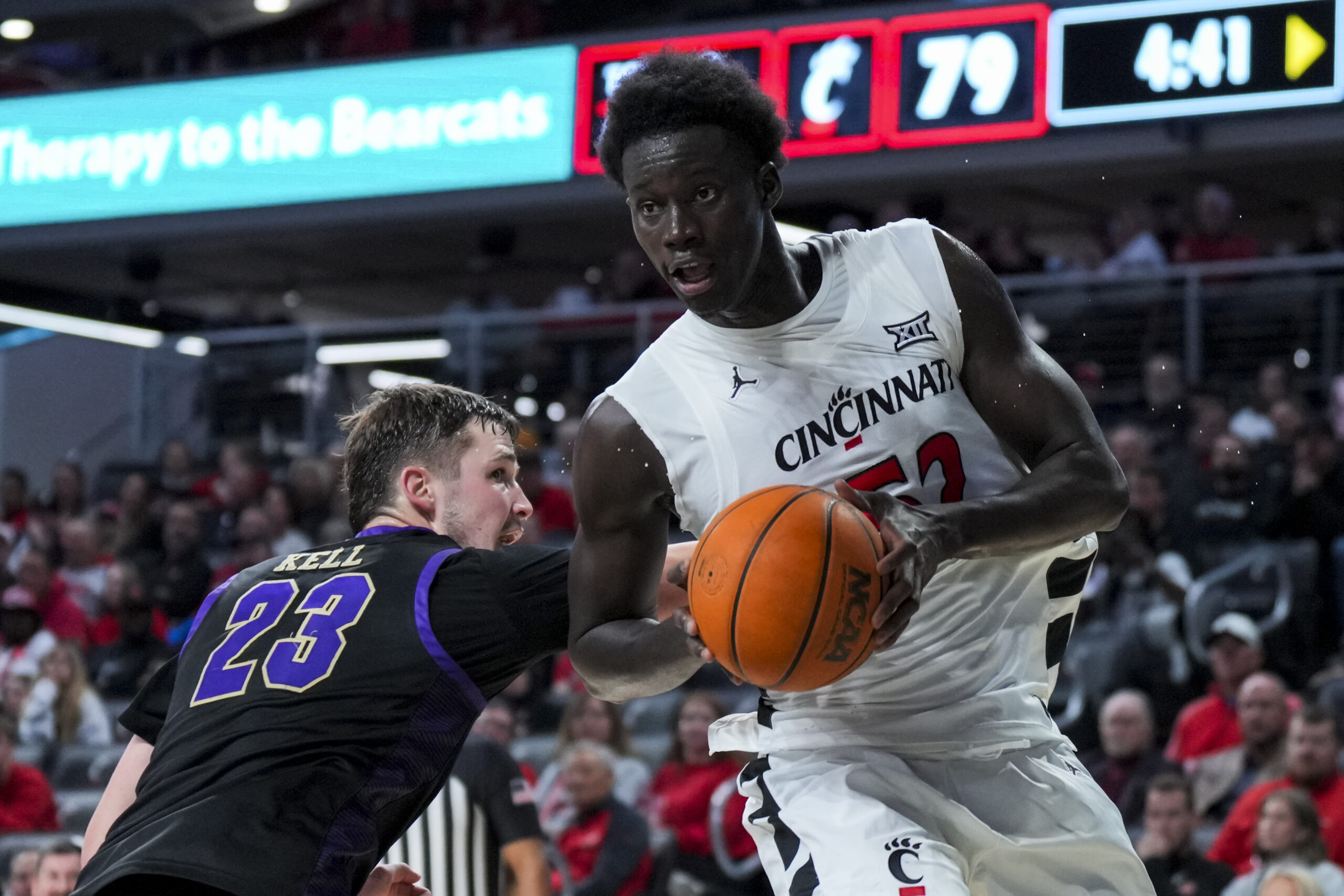 Nov 3, 2025; Cincinnati, Ohio, USA;  Cincinnati Bearcats center Moustapha Thiam (52) drives to the basket against Western Carolina Catamounts forward Marcus Kell (23) in the second half at Fifth Third Arena. Mandatory Credit: Aaron Doster-Imagn Images