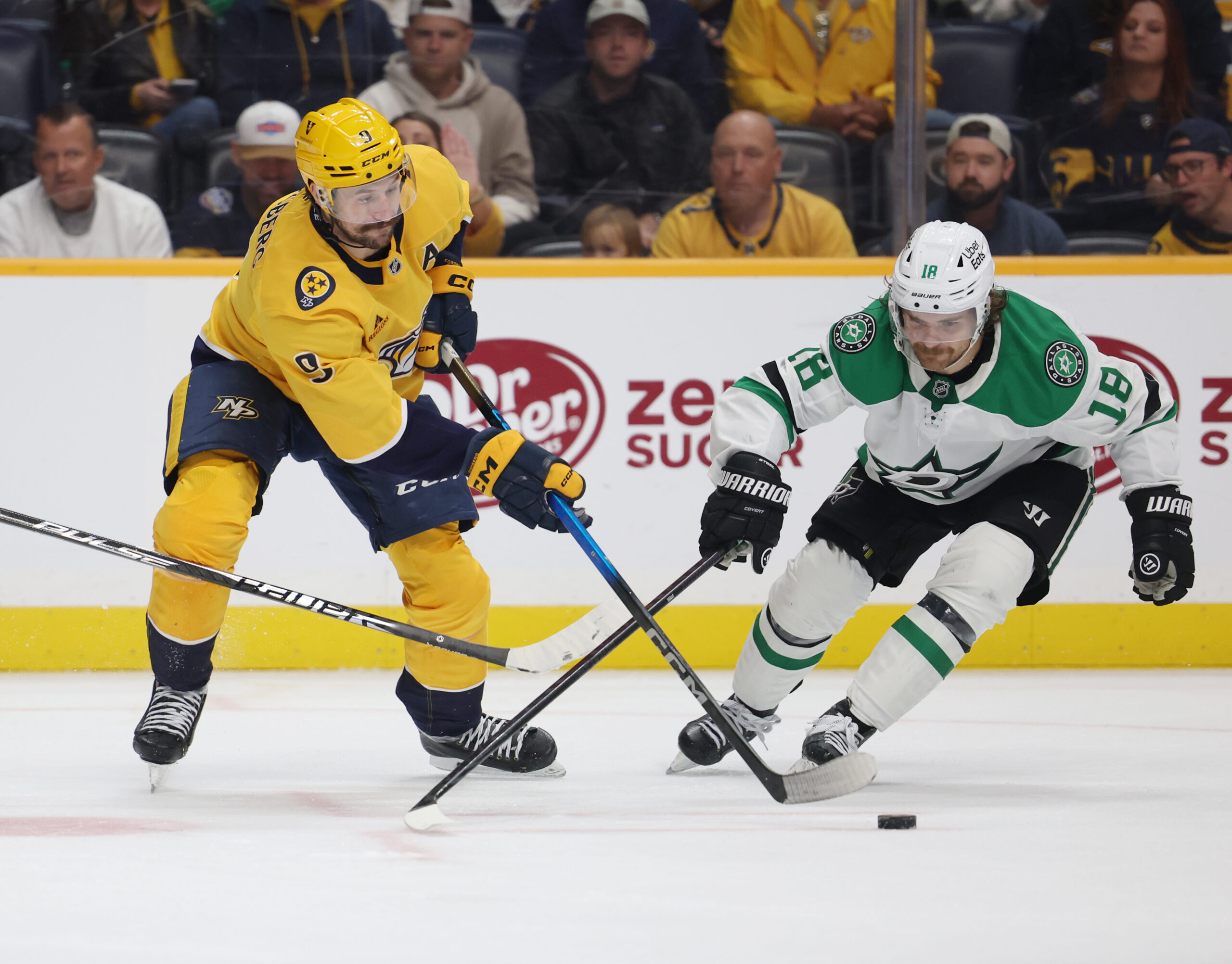 Nov 8, 2025; Nashville, Tennessee, USA; Nashville Predators left wing Filip Forsberg (9) moves the puck as Dallas Stars center Sam Steel (18) defends during the third period at Bridgestone Arena. Mandatory Credit: Alan Poizner-Imagn Images