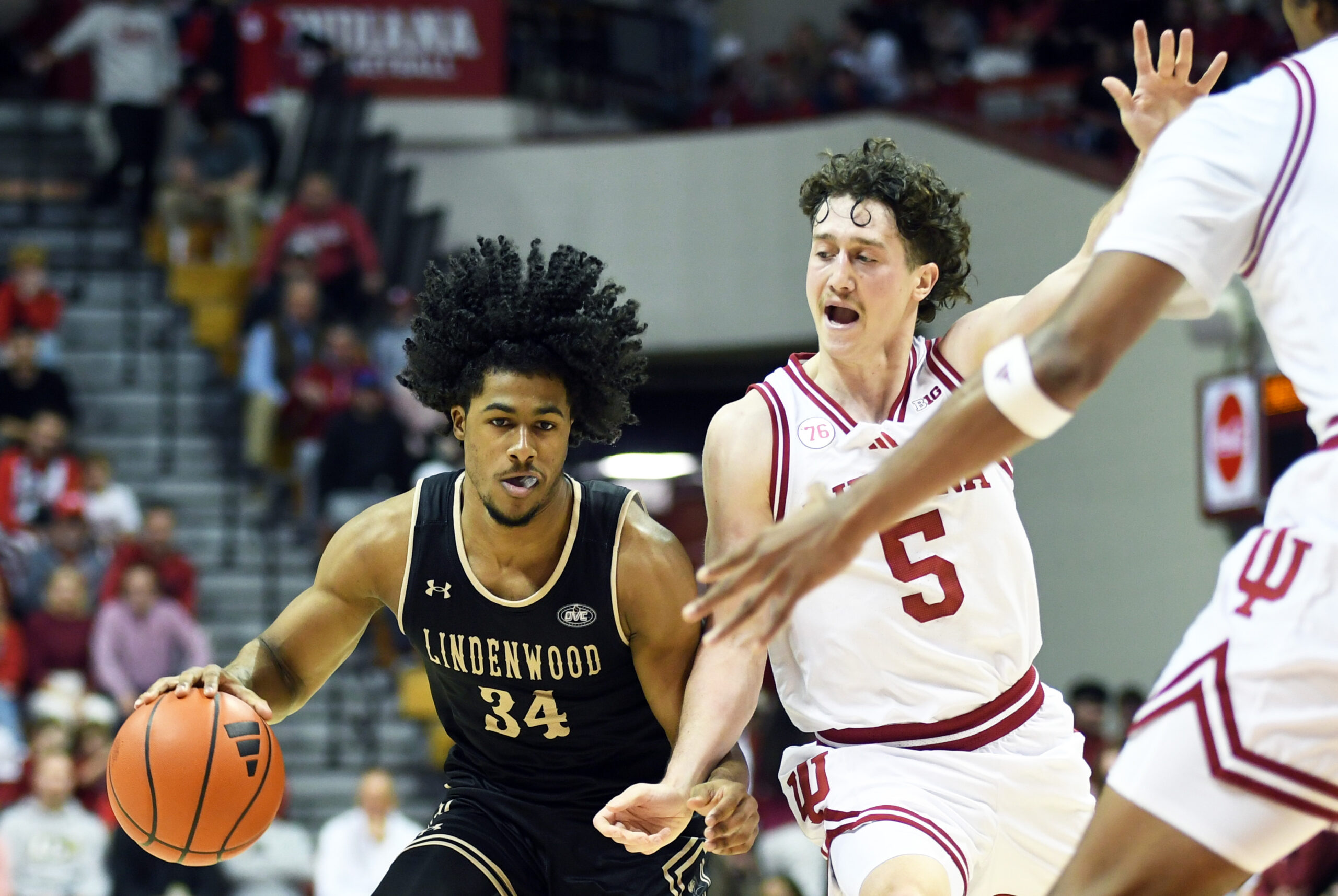Nov 20, 2025; Bloomington, Indiana, USA; Lindenwood Lions guard Clayton Jackson (34) drives to the basket against Indiana Hoosiers guard Conor Enright (5) during the second half at Simon Skjodt Assembly Hall. Mandatory Credit: Robert Goddin-Imagn Images