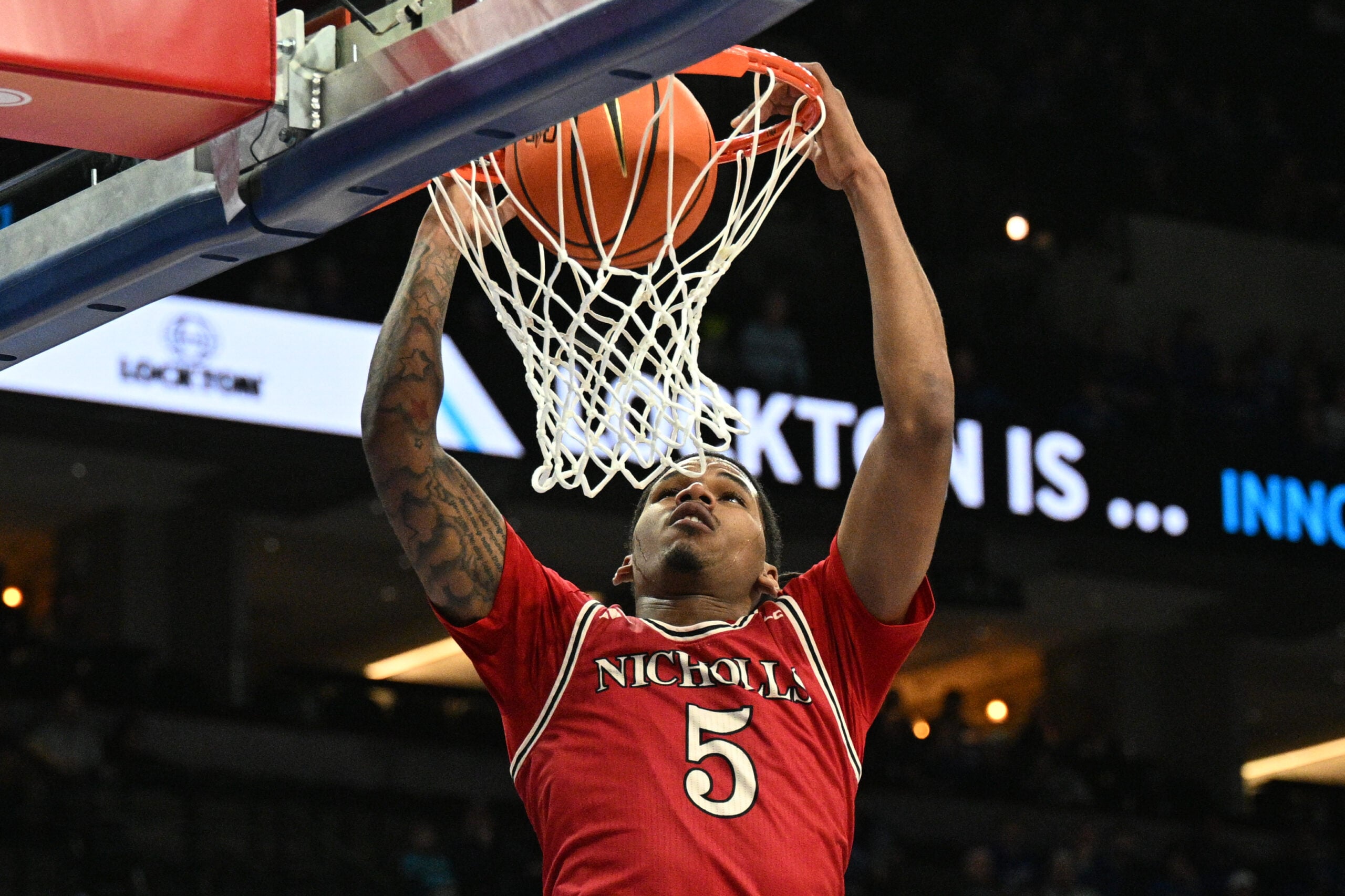 Dec 2, 2025; Omaha, Nebraska, USA;  Nicholls State Colonels forward Sincere Malone (5) dunks against the Creighton Bluejays during the first half at CHI Health Center Omaha. Mandatory Credit: Steven Branscombe-Imagn Images