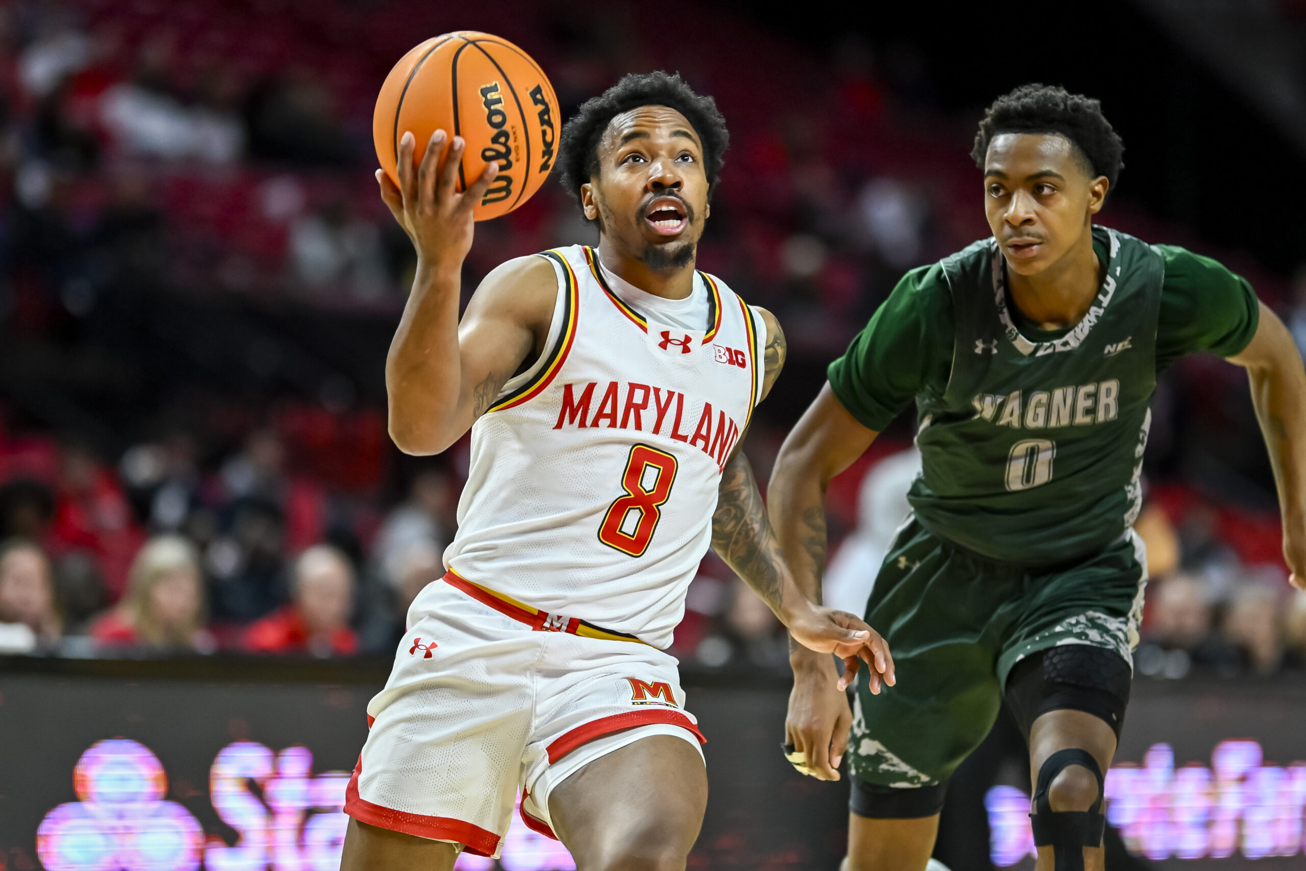 Dec 2, 2025; College Park, Maryland, USA; Maryland Terrapins guard David Coit (8) makes a move to the basket on Wagner Seahawks guard Nick Jones (0) during the second half at Xfinity Center. Mandatory Credit: Tommy Gilligan-Imagn Images