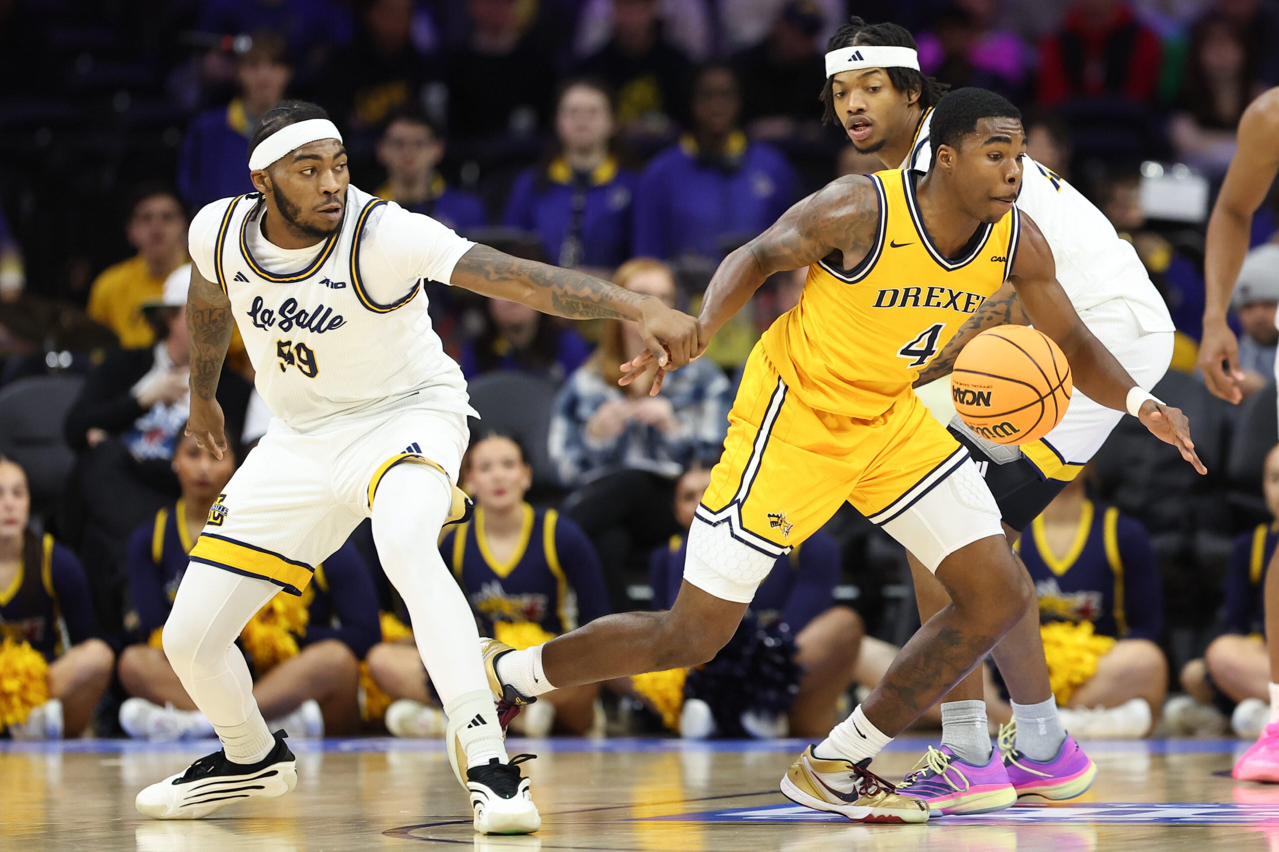 Dec 6, 2025; Philadelphia, PA, USA; La Salle Explorers guard Rob Dockery (99) grabs the wrist of Drexel Dragons guard Shane Blakeney (4) during the second half at Xfinity Mobile Arena. Mandatory Credit: Bill Streicher-Imagn Images