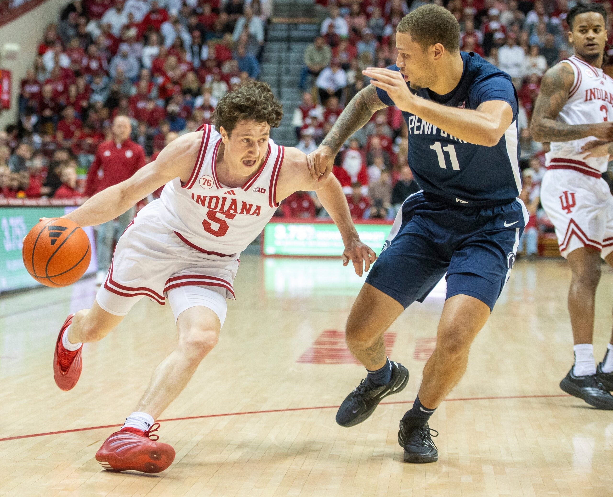 Indiana's Conor Enright (5) drives on Penn State's Eli Rice (11) during the Indiana versus Penn State men's basketball game at Simon Skjodt Assembly Hall on Tuesday, Dec. 9, 2025.