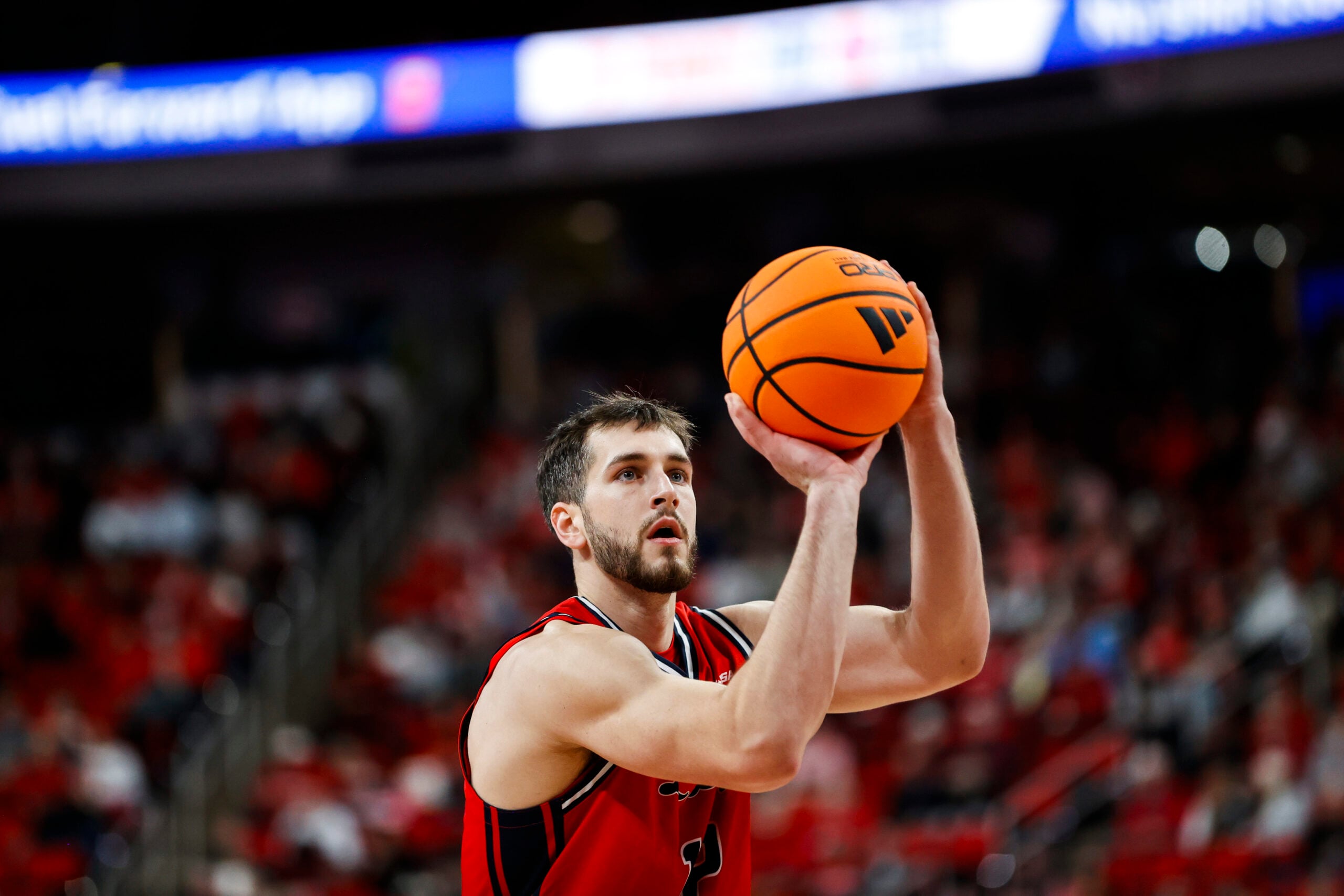 Dec 6, 2025; Raleigh, North Carolina, USA; Liberty Flames forward Josh Smith (12) shoots a free throw during the second half of the game against the NC State Wolfpack at Lenovo Center. Mandatory Credit: Jaylynn Nash-Imagn Images