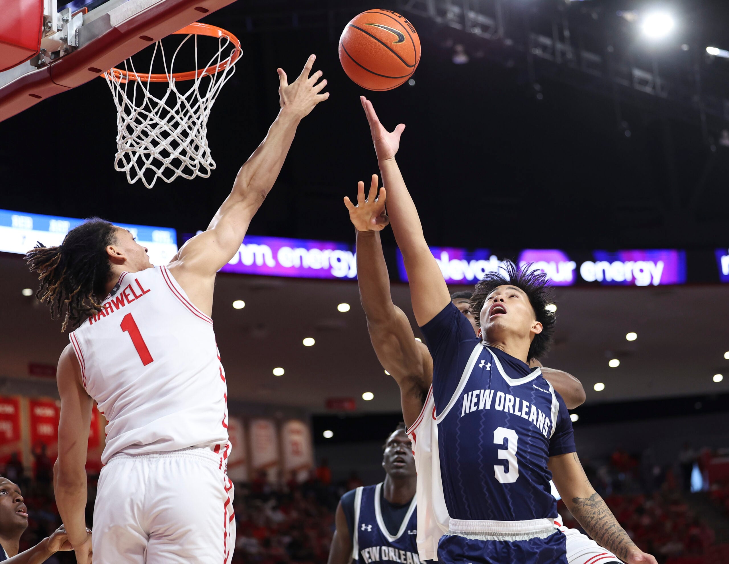 Dec 13, 2025; Houston, Texas, USA; Houston Cougars guard Isiah Harwell (1) and New Orleans Privateers guard Irish Coquia (3) battle for a loose ball during the first half at Fertitta Center. Mandatory Credit: Troy Taormina-Imagn Images