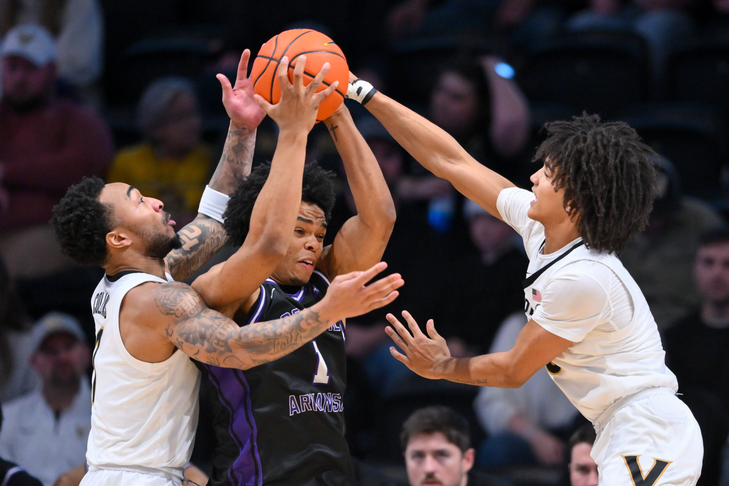 Dec 13, 2025; Nashville, Tennessee, USA; Vanderbilt Commodores guard Frankie Collins (1) and guard Tyler Tanner (3) trap Central Arkansas Bears guard Camren Hunter (1)  during the second half at Memorial Gymnasium. Mandatory Credit: Steve Roberts-Imagn Images