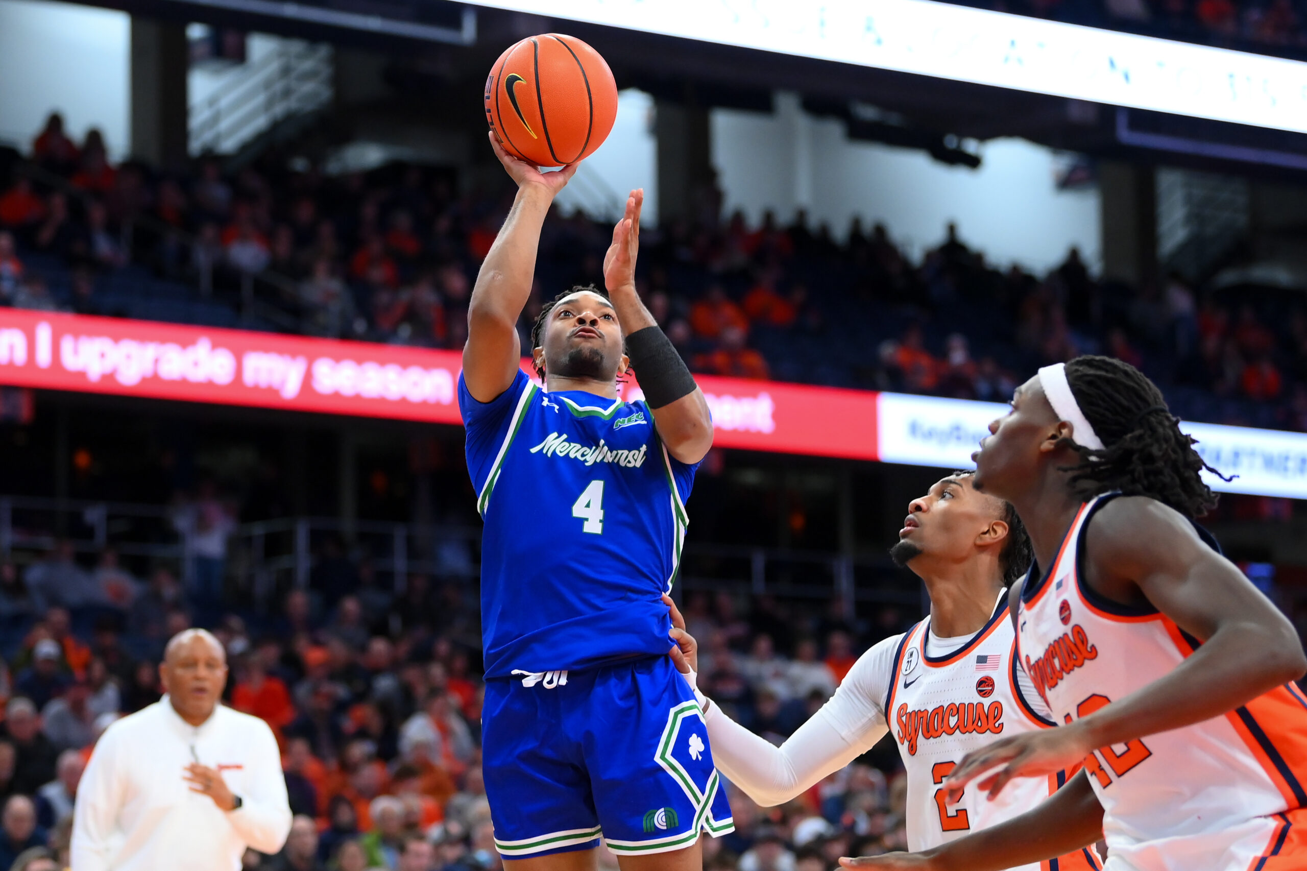 Dec 17, 2025; Syracuse, New York, USA; Mercyhurst Lakers guard Bernie Blunt (4) shoots against Syracuse Orange guard J.J. Starling (2) and forward William Kyle III (42) during the first half at the JMA Wireless Dome. Mandatory Credit: Rich Barnes-Imagn Images
