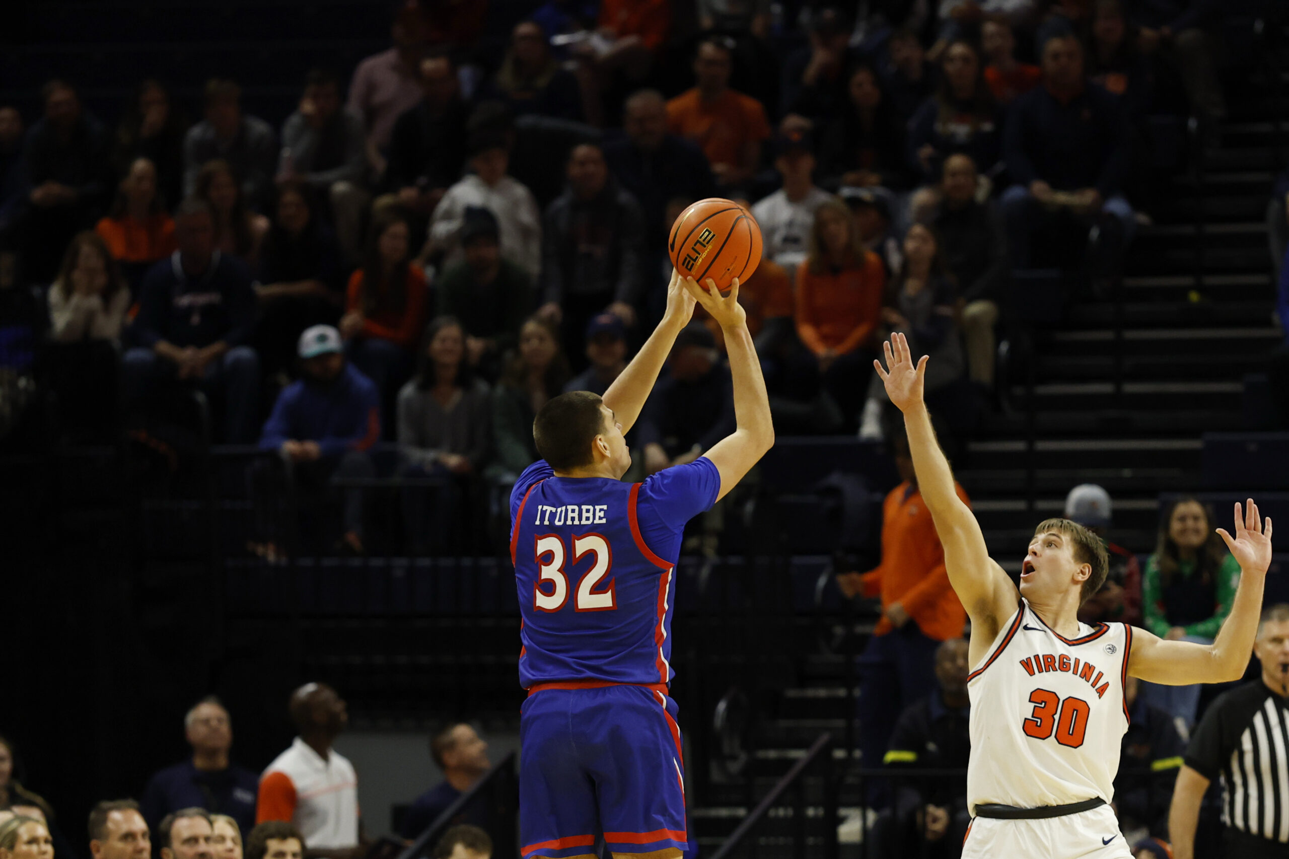 Dec 22, 2025; Charlottesville, Virginia, USA; American University Eagles forward Julen Iturbe (32) shoots the ball over Virginia Cavaliers guard Dallin Hall (30) in the second half at John Paul Jones Arena. Mandatory Credit: Geoff Burke-Imagn Images