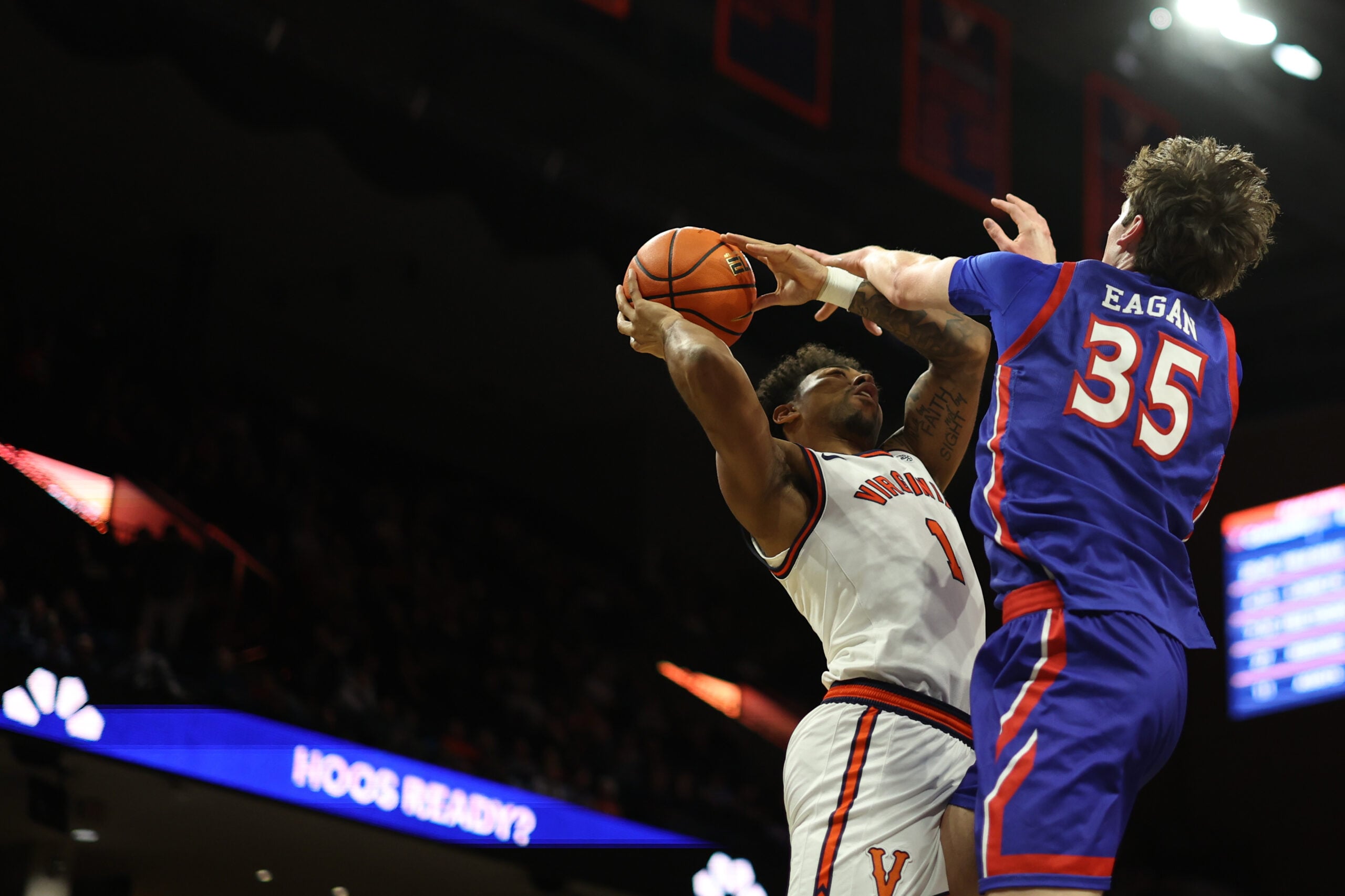 Dec 22, 2025; Charlottesville, Virginia, USA; Virginia Cavaliers guard Malik Thomas (1) shoots the ball as American University Eagles forward Chris Eagan (35) defends in the second half at John Paul Jones Arena. Mandatory Credit: Geoff Burke-Imagn Images