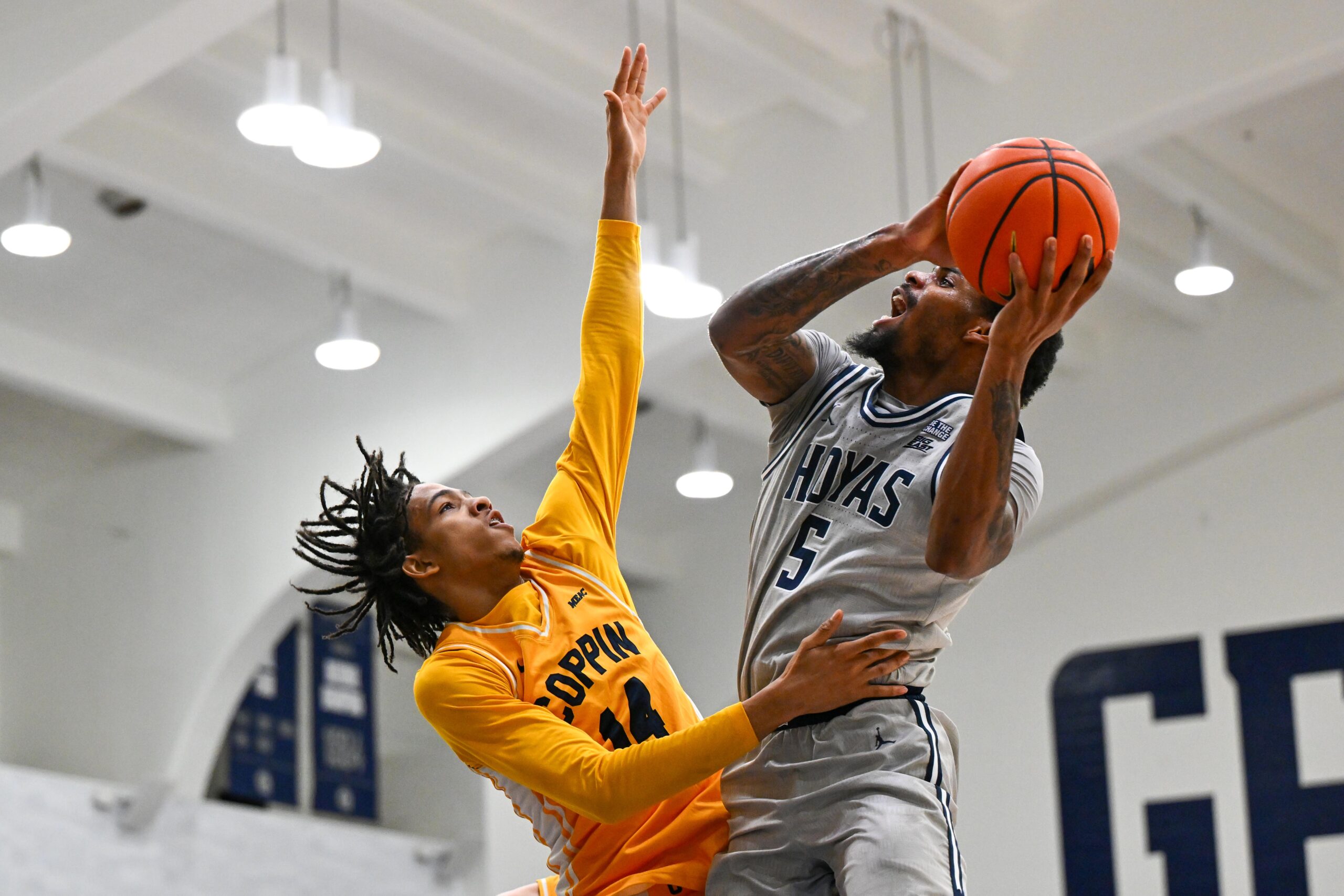 Dec 22, 2025; Washington, District of Columbia, USA; Georgetown Hoyas guard Kj Lewis (5) is fouled by Coppin State Eagles guard Jamari Piercy (14) during the first half at McDonough Arena. Mandatory Credit: Brad Mills-Imagn Images