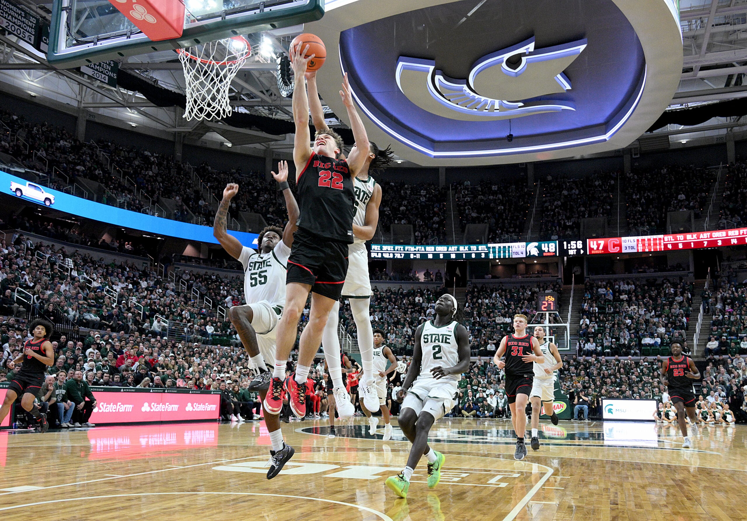 Dec 29, 2025; East Lansing, Michigan, USA; Cornell Big Red guard Jake Fiegen (22) gets his layup blocked by Michigan State Spartans forward Jordan Scott (6) during the first half at Jack Breslin Student Events Center. Mandatory Credit: Dale Young-Imagn Images