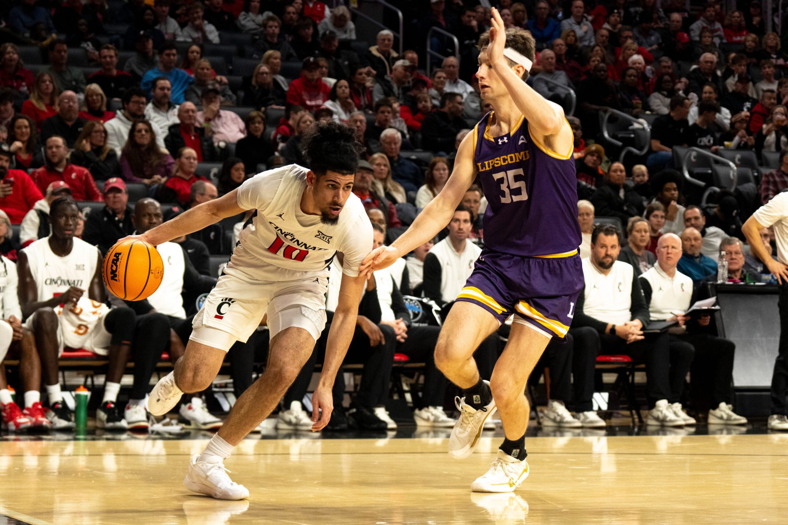 Cincinnati Bearcats guard Shon Abaev (10) drives on Lipscomb Bisons forward Grant Asman (35) in the second half of the NCAA basketball game at Fifth Third Arena in Cincinnati on Dec. 29, 2025.