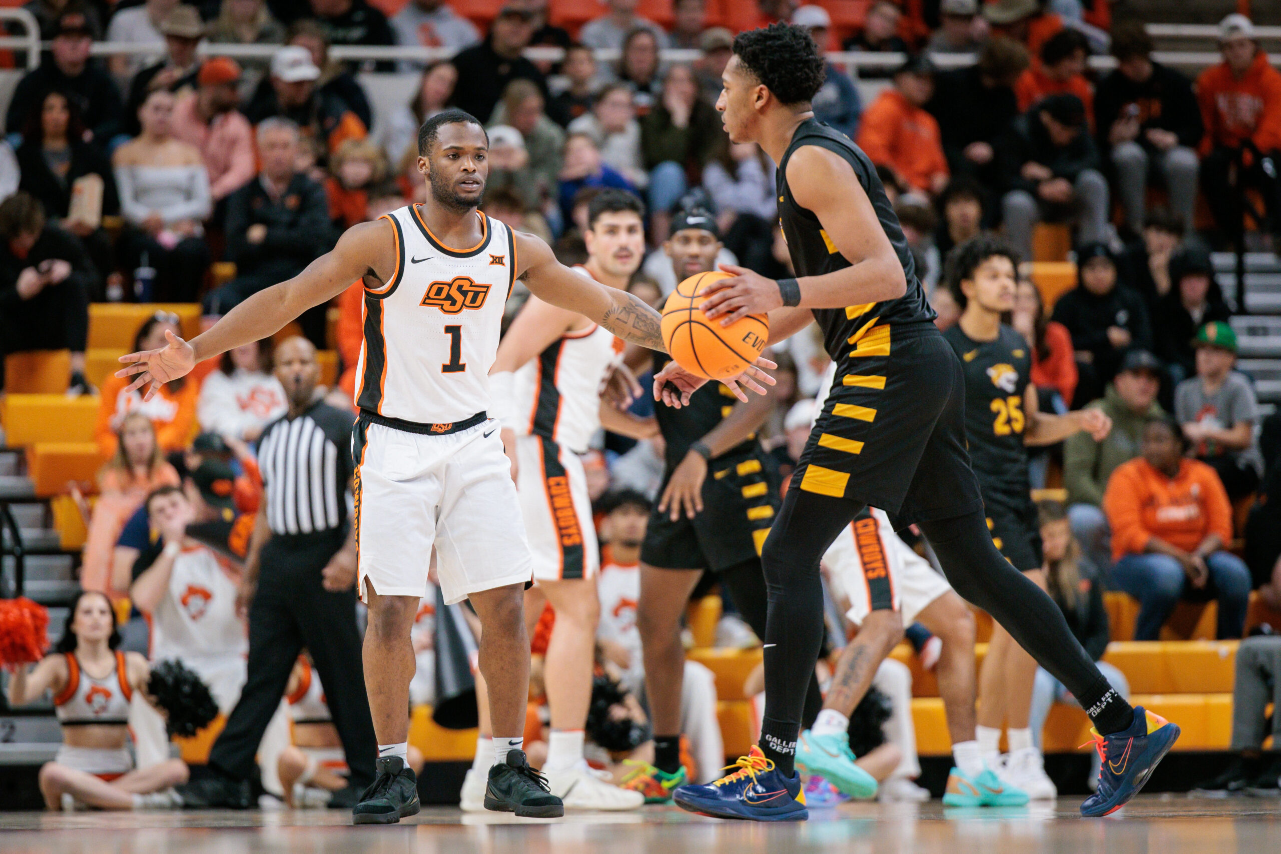 Dec 29, 2025; Stillwater, Oklahoma, USA; Oklahoma State Cowboys guard Kanye Clary (1) guards Bethune-Cookman Wildcats forward Ariel Bland (4) during the second half at Gallagher-Iba Arena. Mandatory Credit: William Purnell-Imagn Images