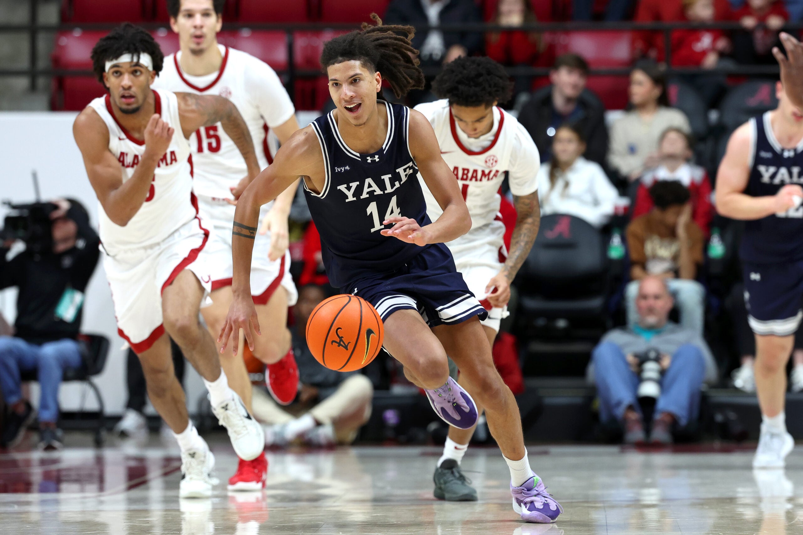 Dec 29, 2025; Tuscaloosa, Alabama, USA; Yale Bulldogs guard Casey Simmons (14) goes on a fast break during the second half against the Alabama Crimson Tide at Coleman Coliseum. Mandatory Credit: David Leong-Imagn Images