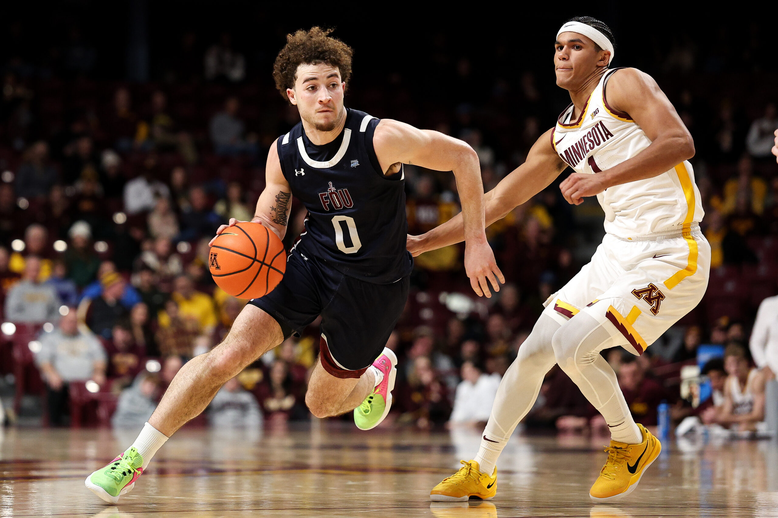 Dec 29, 2025; Minneapolis, Minnesota, USA; Fairleigh Dickinson Knights guard Joey Niesman (0) works around Minnesota Golden Gophers guard Isaac Asuma (1) during the second half at Williams Arena. Mandatory Credit: Matt Krohn-Imagn Images