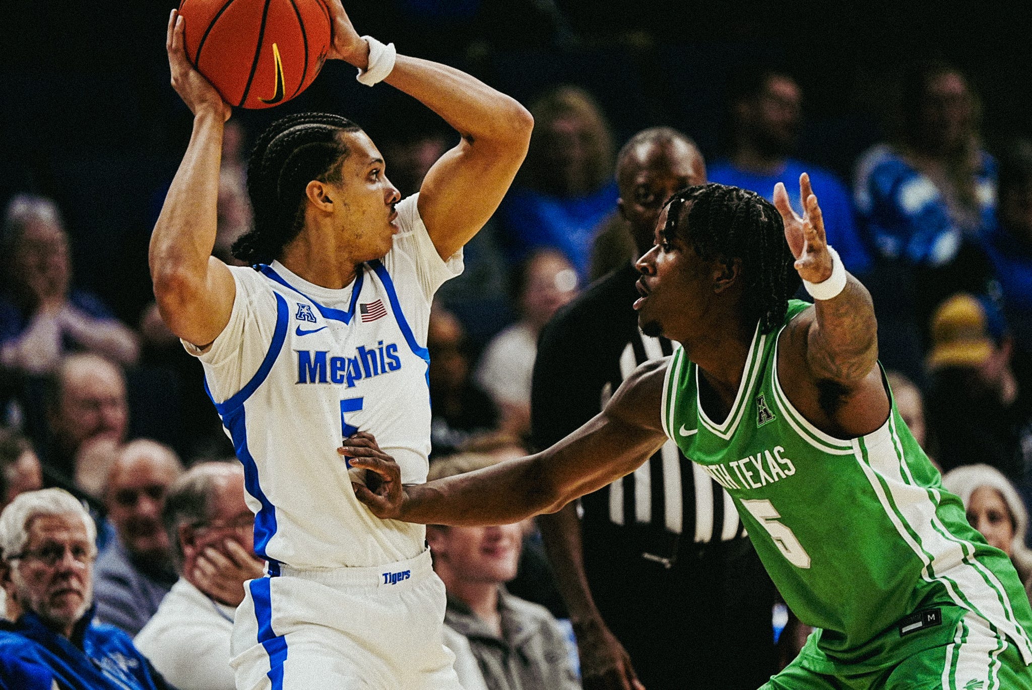 Memphis Tiger Curtis Givens III (5) looks to make a pass against North Texas’ David Terrell Jr. (5) during a game on Dec. 31, 2025 at the FedExForum in Memphis, Tenn.