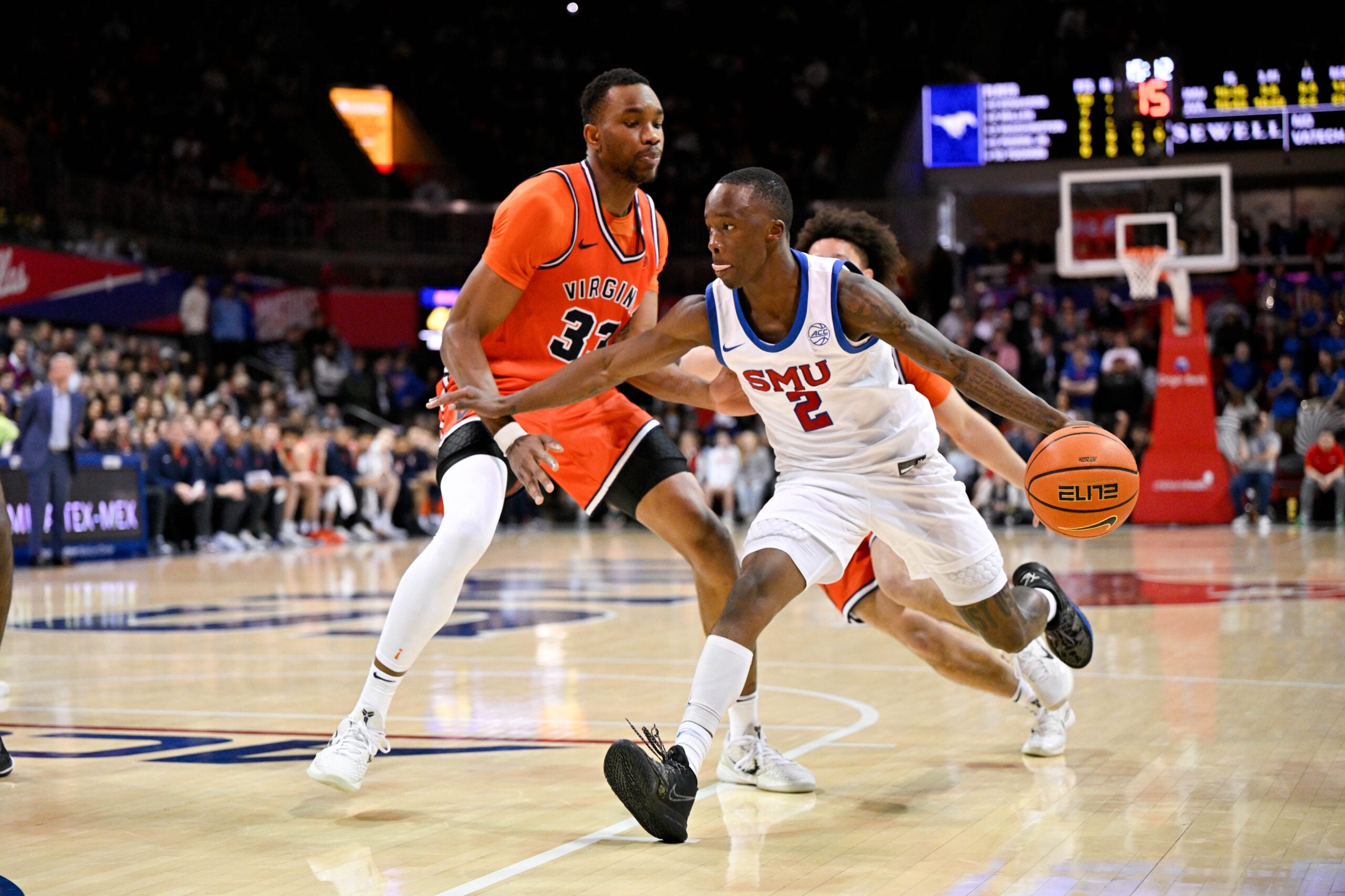 Jan 17, 2026; Dallas, Texas, USA; SMU Mustangs guard Boopie Miller (2) controls the ball in front of Virginia Cavaliers center Ugonna Onyenso (33) during the second half at Moody Coliseum. Mandatory Credit: Jerome Miron-Imagn Images