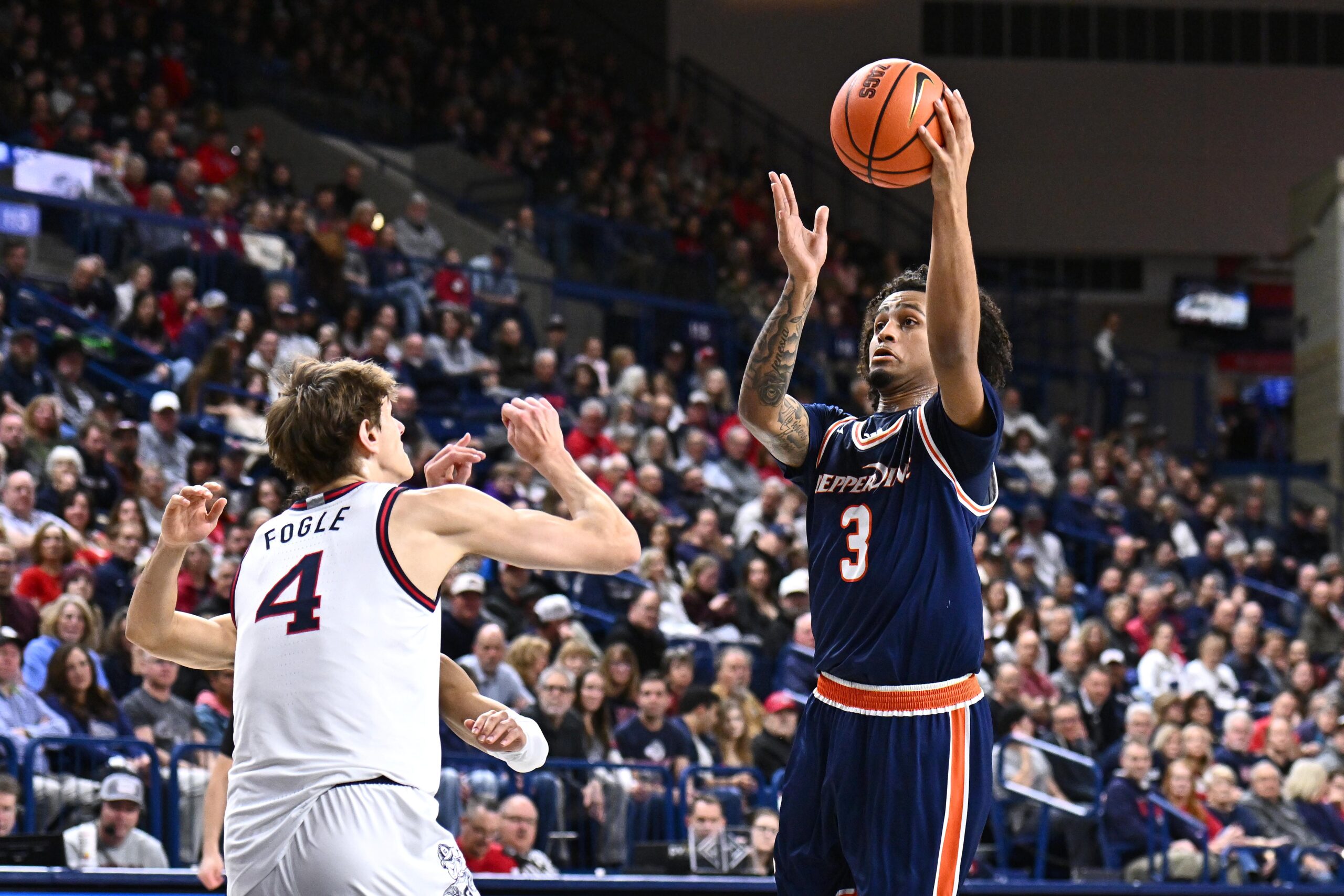 Jan 21, 2026; Spokane, Washington, USA; Pepperdine Waves guard Aaron Clark (3) shoots the ball against Gonzaga Bulldogs guard Davis Fogle (4) in the first half at McCarthey Athletic Center. Mandatory Credit: James Snook-Imagn Images
