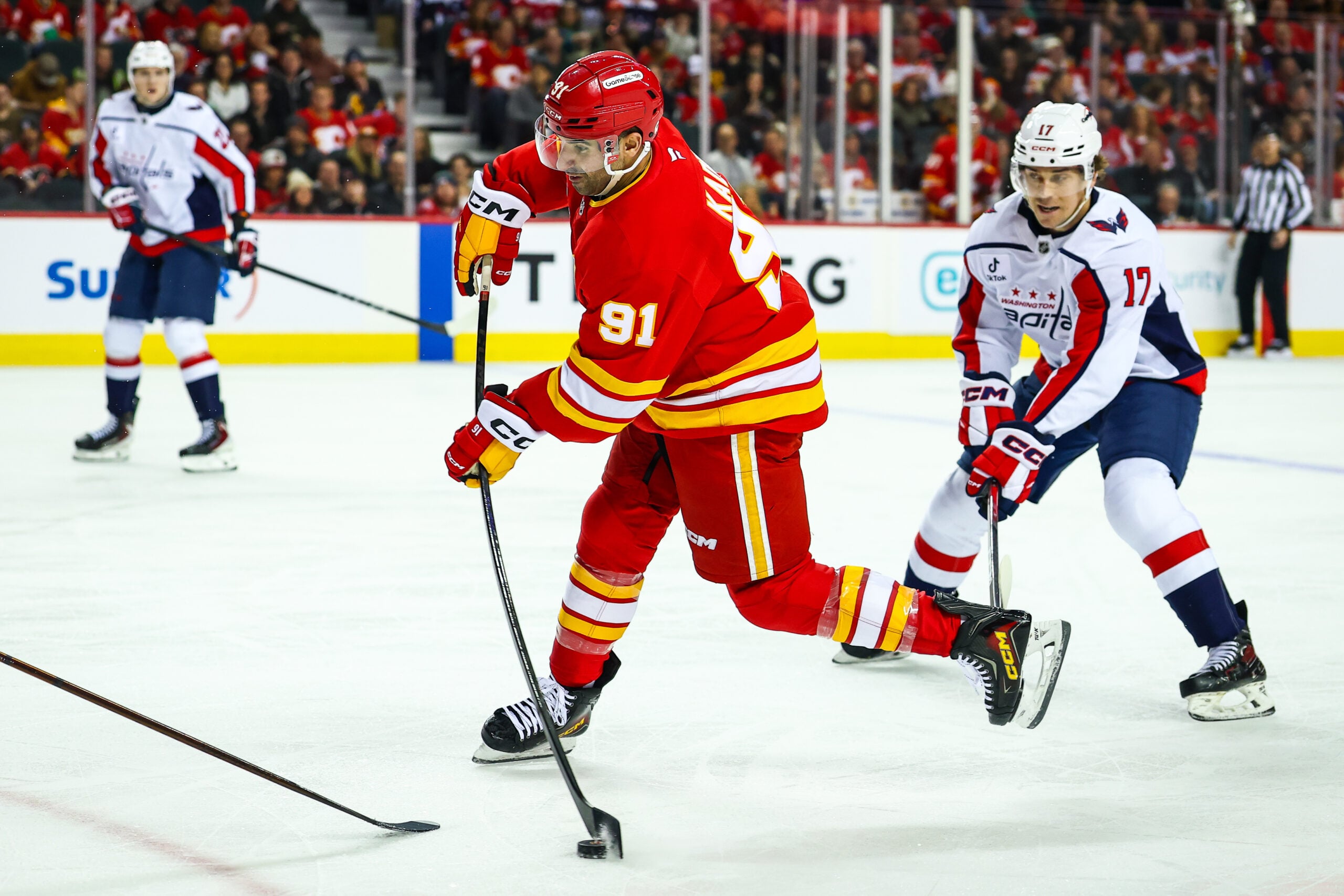 Jan 23, 2026; Calgary, Alberta, CAN; Calgary Flames center Nazem Kadri (91) shoots the puck against the Washington Capitals during the second period at Scotiabank Saddledome. Mandatory Credit: Sergei Belski-Imagn Images