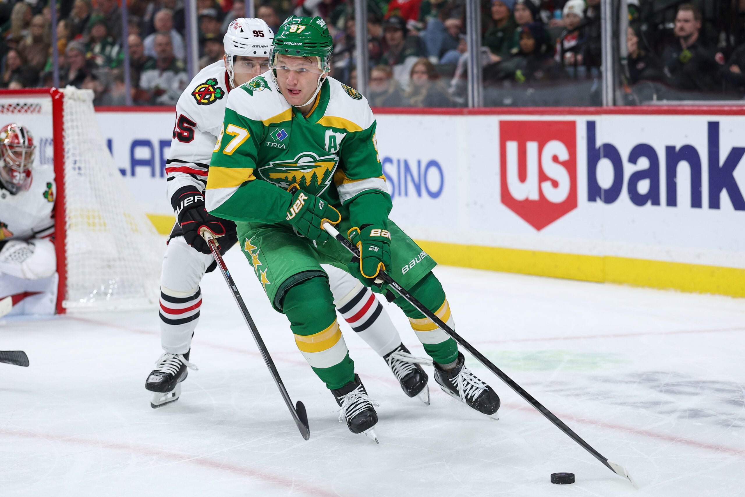 Jan 27, 2026; Saint Paul, Minnesota, USA; Minnesota Wild left wing Kirill Kaprizov (97) skates with the puck as Chicago Blackhawks right wing Ilya Mikheyev (95) defends during the second period at Grand Casino Arena. Mandatory Credit: Matt Krohn-Imagn Images