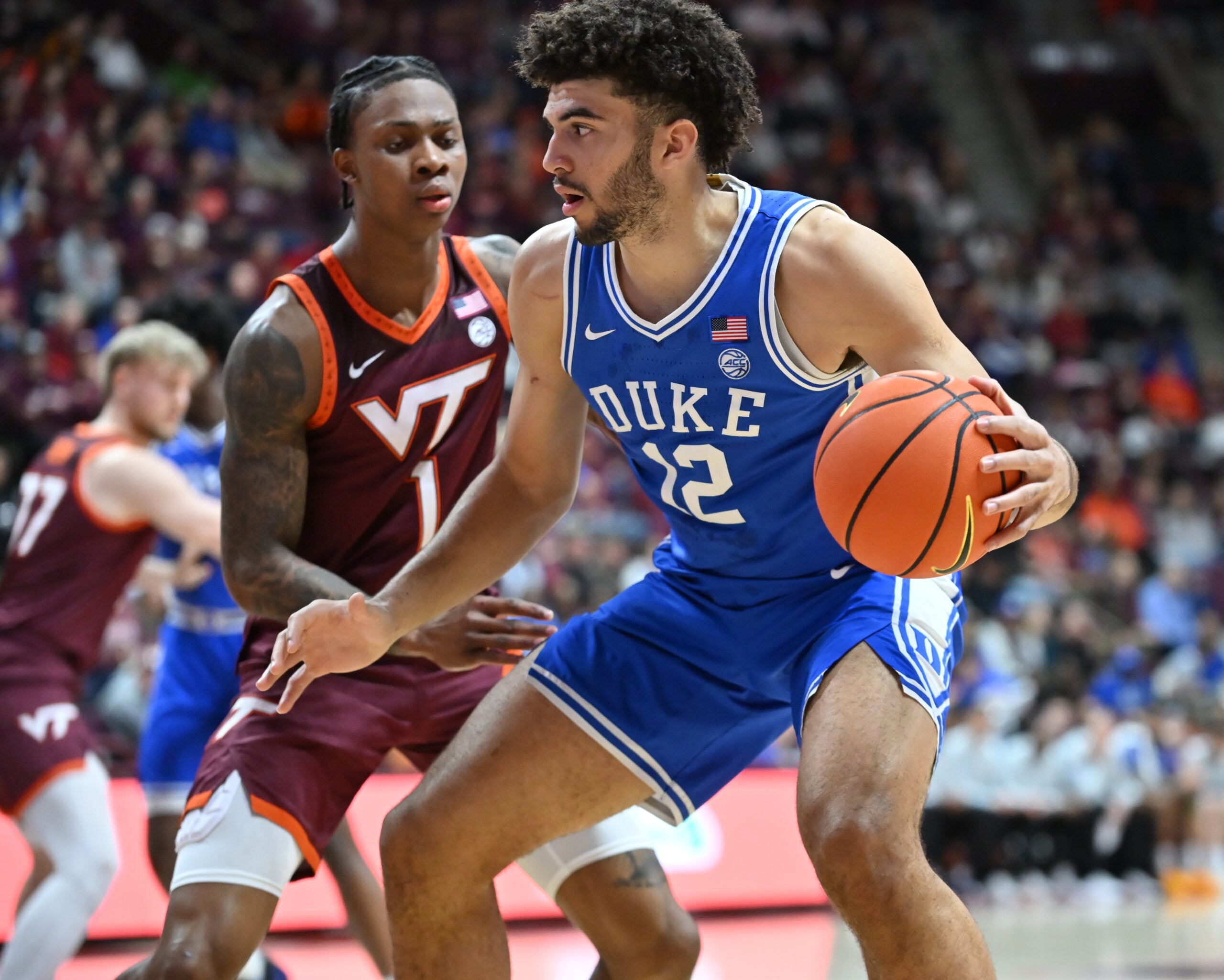Jan 31, 2026; Blacksburg, Virginia, USA; Duke Blue Devils forward Cameron Boozer (12) works against Virginia Tech Hokies forward Tobi Lawal (1) during the first half at Cassell Coliseum. Mandatory Credit: Brian Bishop-Imagn Images
