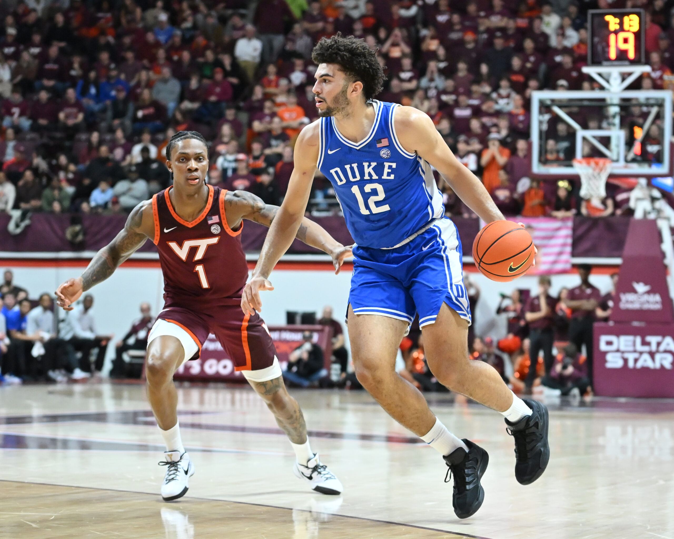 Jan 31, 2026; Blacksburg, Virginia, USA;  Duke Blue Devils forward Cameron Boozer (12) controls the ball as Virginia Tech Hokies forward Tobi Lawal (1) defends during the first half at Cassell Coliseum. Mandatory Credit: Brian Bishop-Imagn Images