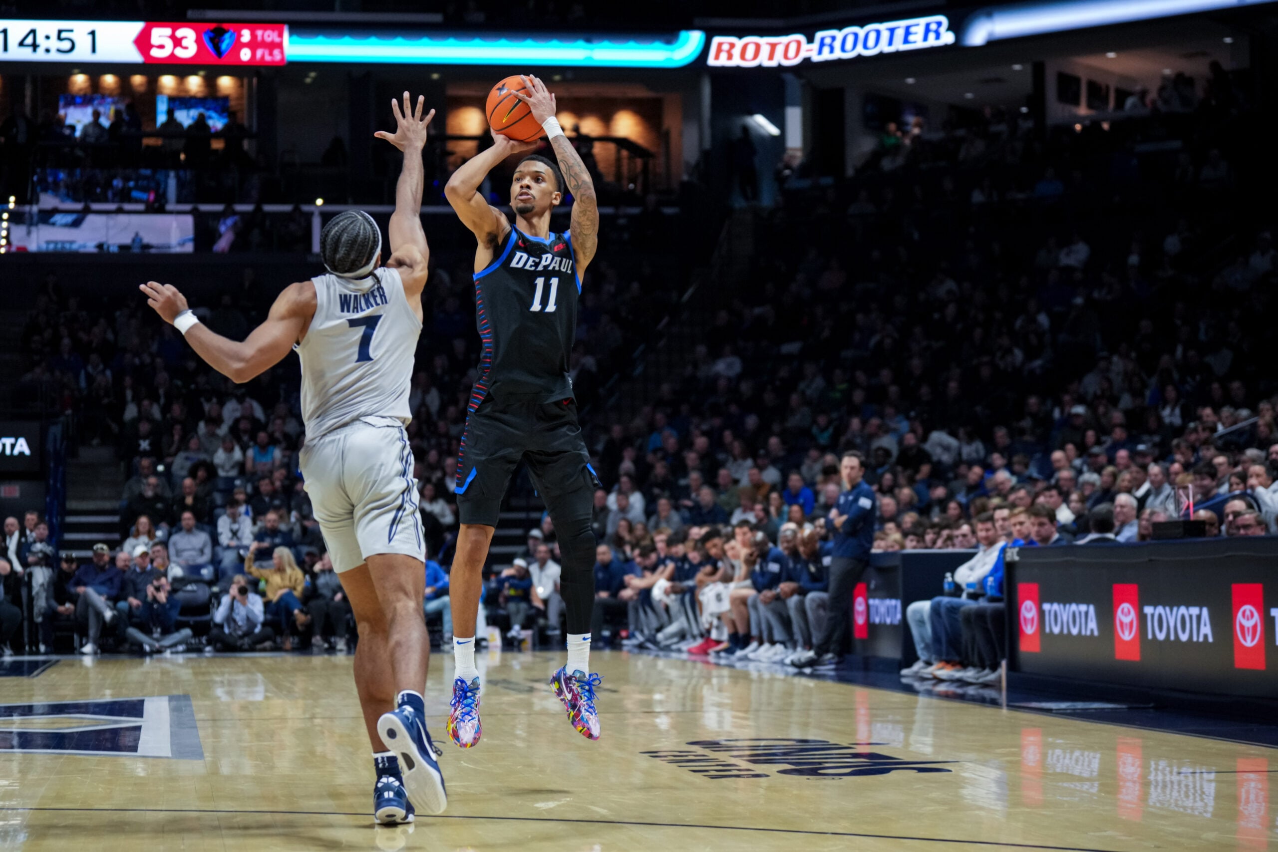 Jan 31, 2026; Cincinnati, Ohio, USA;  DePaul Blue Demons guard CJ Gunn (11) attempts a 3-point shot against Xavier Musketeers guard Isaiah Walker (7) in the second half at the Cintas Center. Mandatory Credit: Aaron Doster-Imagn Images
