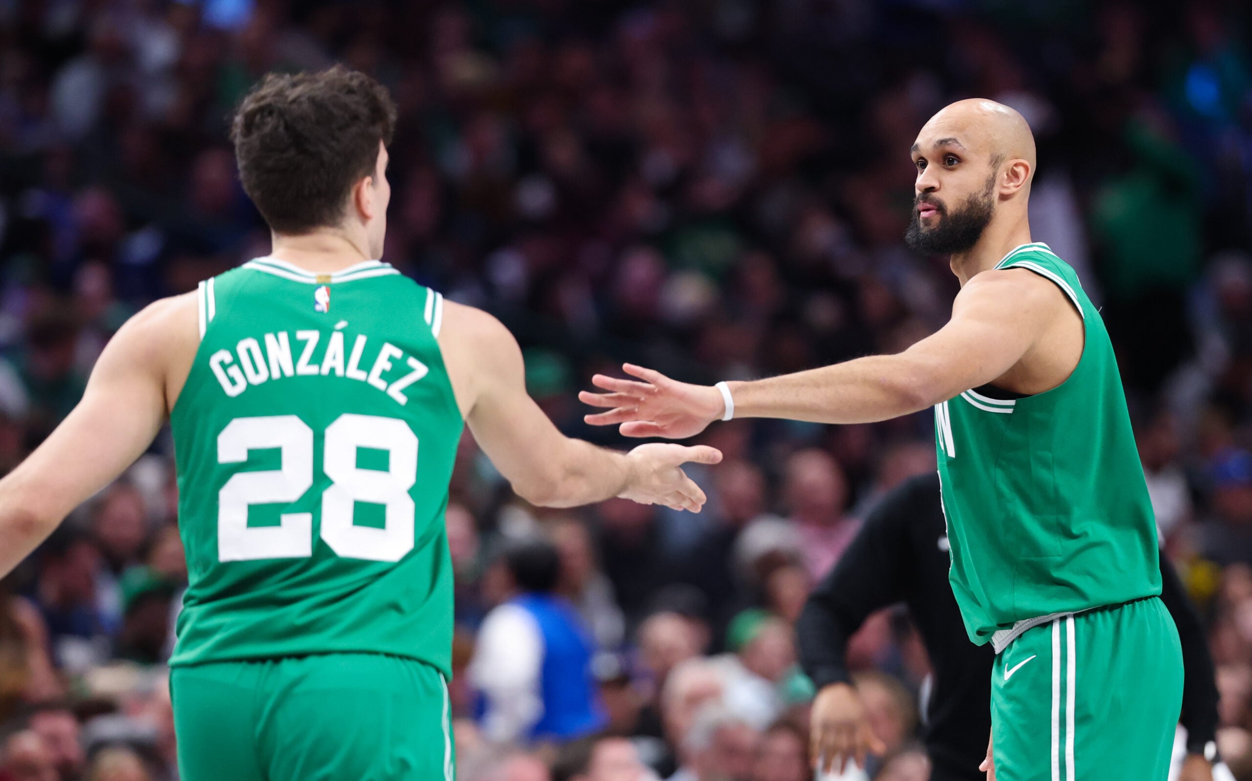 Feb 3, 2026; Dallas, Texas, USA;  Boston Celtics guard Derrick White (9) celebrates with Boston Celtics guard Hugo Gonzalez (28) during the second half against the Dallas Mavericks at American Airlines Center. Mandatory Credit: Kevin Jairaj-Imagn Images