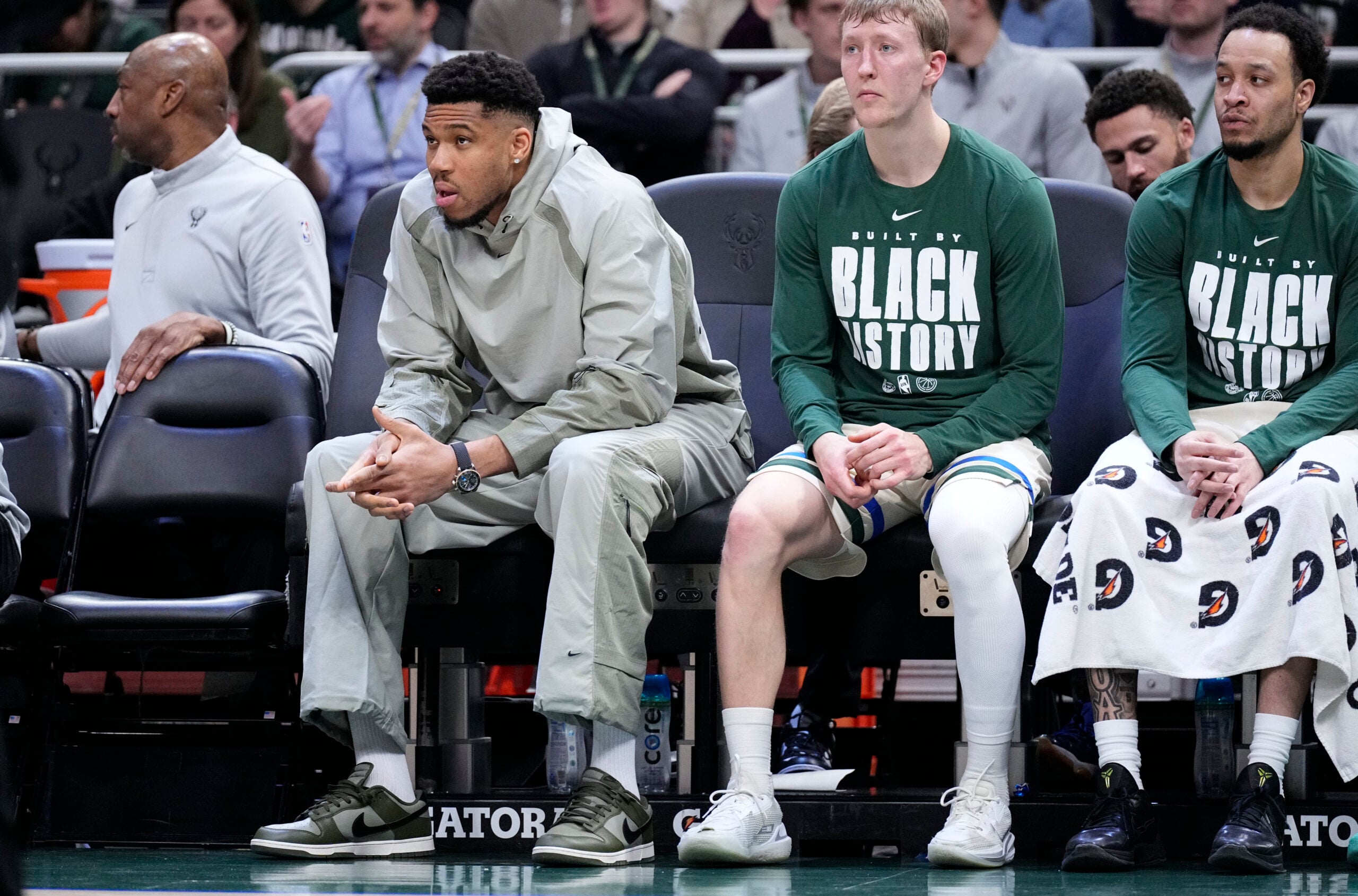 Feb 3, 2026; Milwaukee, Wisconsin, USA; Milwaukee Bucks forward Giannis Antetokounmpo (34), second from left, watches from the bench in the first half against the Chicago Bulls at Fiserv Forum. Mandatory Credit: Michael McLoone-Imagn Images