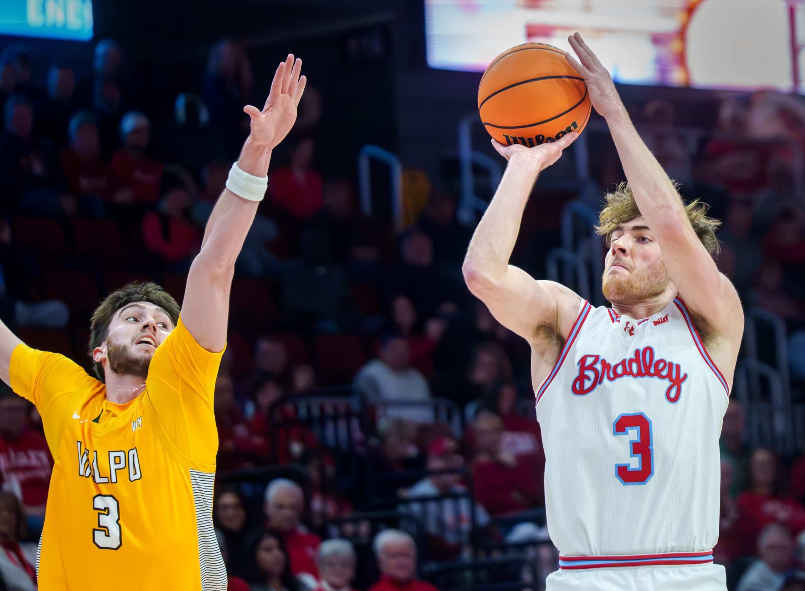Bradley’s Alex Huibregtse, right, puts up a three-pointer over Valparaiso’s Brody Whitaker in the first half of their college basketball game Tuesday, Feb. 3, 2026 at the Peoria Civic Center. The Braves defeated the Beacons 72-65.
