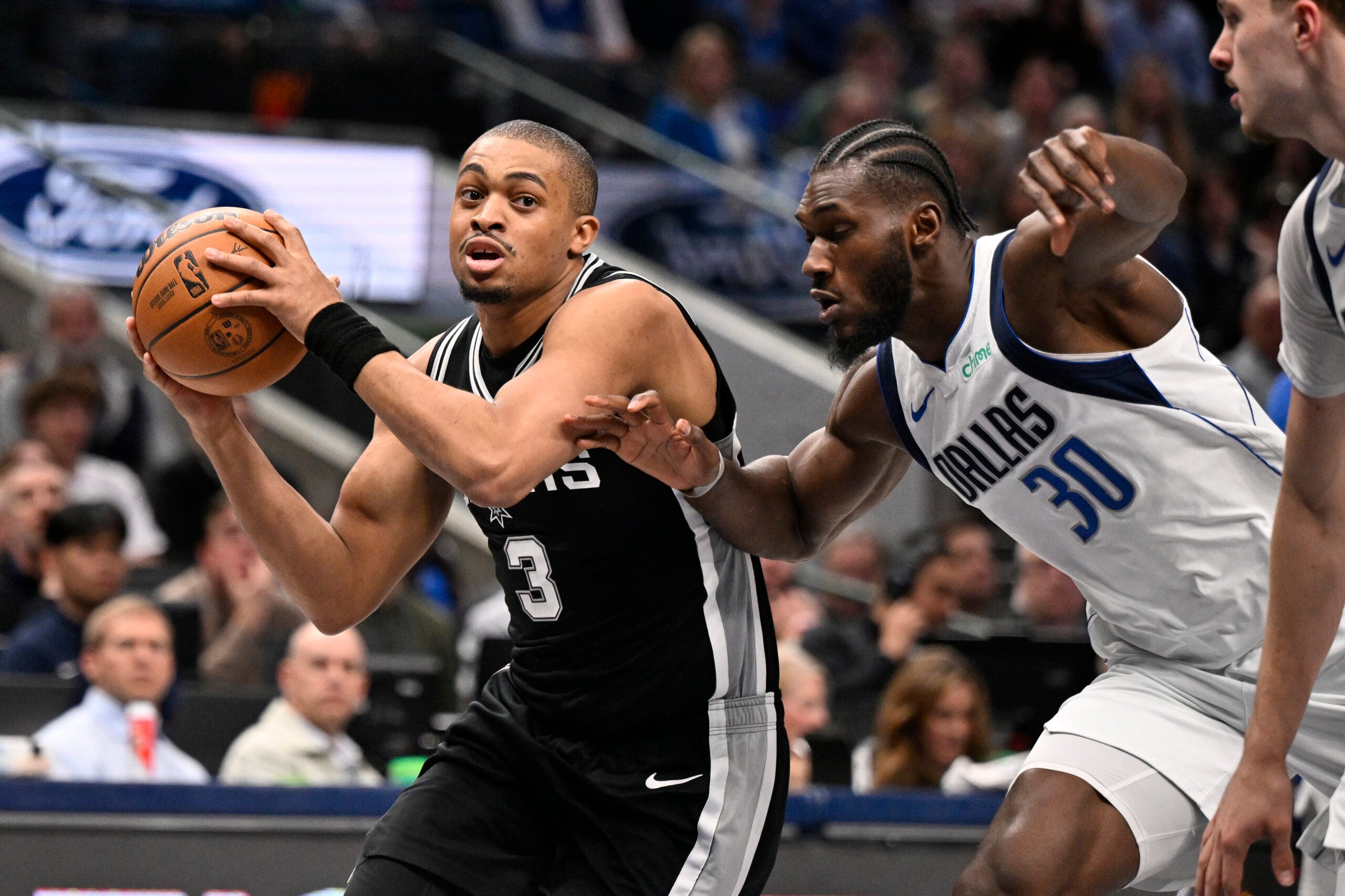 Feb 5, 2026; Dallas, Texas, USA; San Antonio Spurs forward Keldon Johnson (3) drives to the basket past Dallas Mavericks center Moussa Cisse (30) during the second half at the American Airlines Center. Mandatory Credit: Jerome Miron-Imagn Images