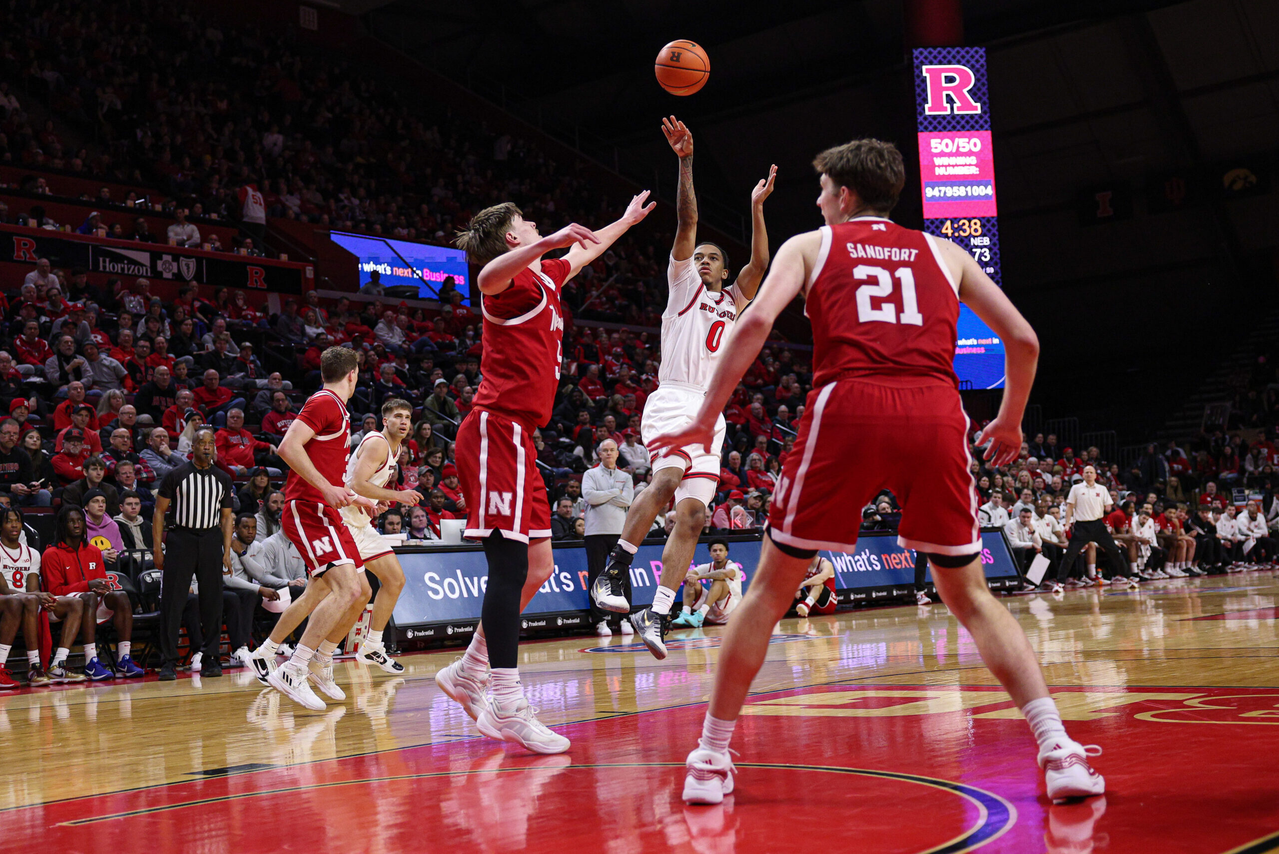Feb 7, 2026; Piscataway, New Jersey, USA; Rutgers Scarlet Knights guard Tariq Francis (0) shoots the ball against Nebraska Cornhuskers forward Braden Frager (5)  during the second half at Jersey Mike's Arena. Mandatory Credit: Vincent Carchietta-Imagn Images