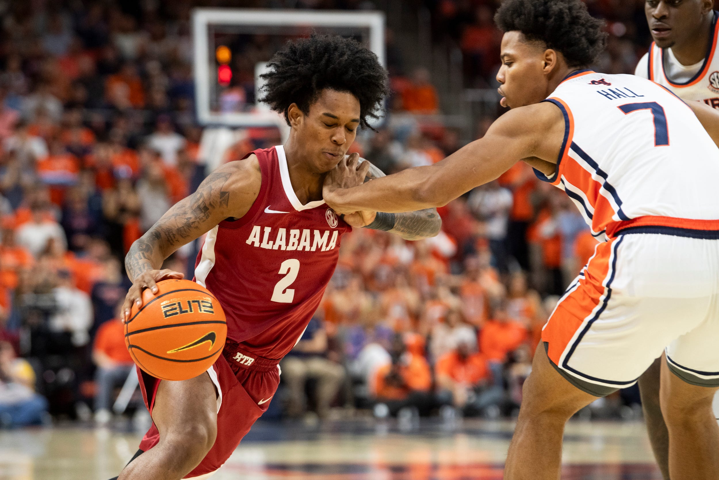 Alabama Crimson Tide guard Aden Holloway (2) drives on Auburn Tigers forward Keyshawn Hall (7) as Auburn Tigers take on Alabama Crimson Tide at Neville Arena in Auburn, Ala. on Saturday, Feb. 7, 2026.