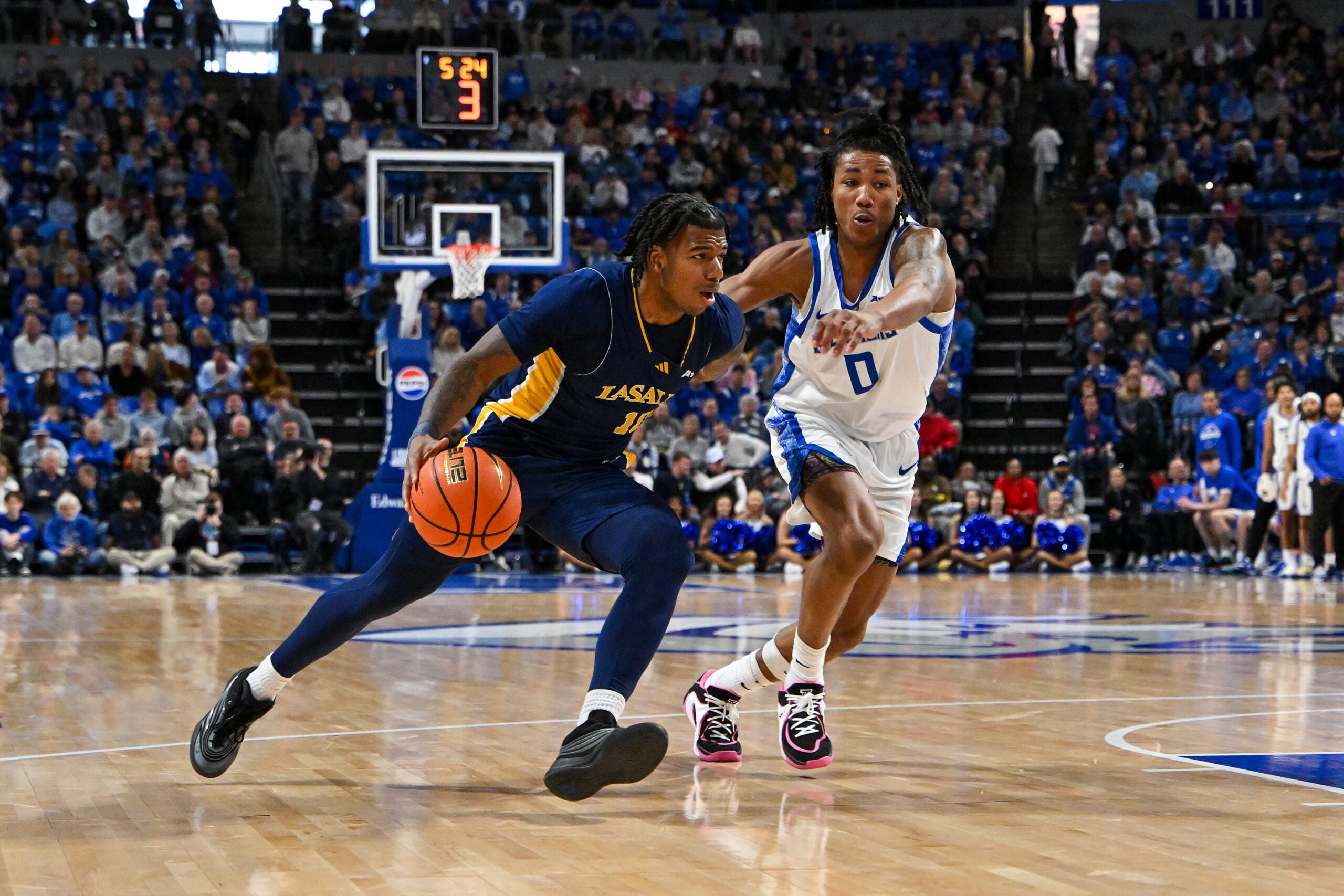 Feb 7, 2026; St. Louis, Missouri, USA; La Salle Explorers guard Jaden Johnson (10) drives to the basket as Saint Louis Billikens guard Kellen Thames (0) defends during the second half at Chaifetz Arena. Mandatory Credit: Jeff Curry-Imagn Images