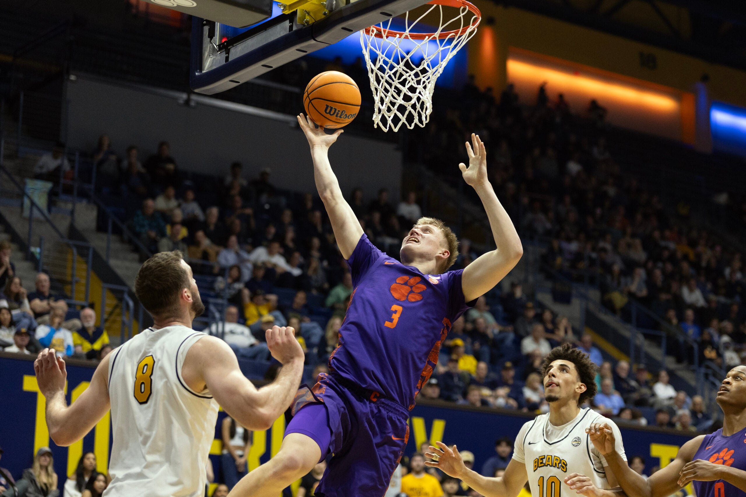Feb 7, 2026; Berkeley, California, USA; Clemson Tigers forward Chase Thompson (3) lays the ball up between California Golden Bears defenders Milos Ilić (8) and Justin Pippen (10) during the first half at Haas Pavilion. Mandatory Credit: D. Ross Cameron-Imagn Images