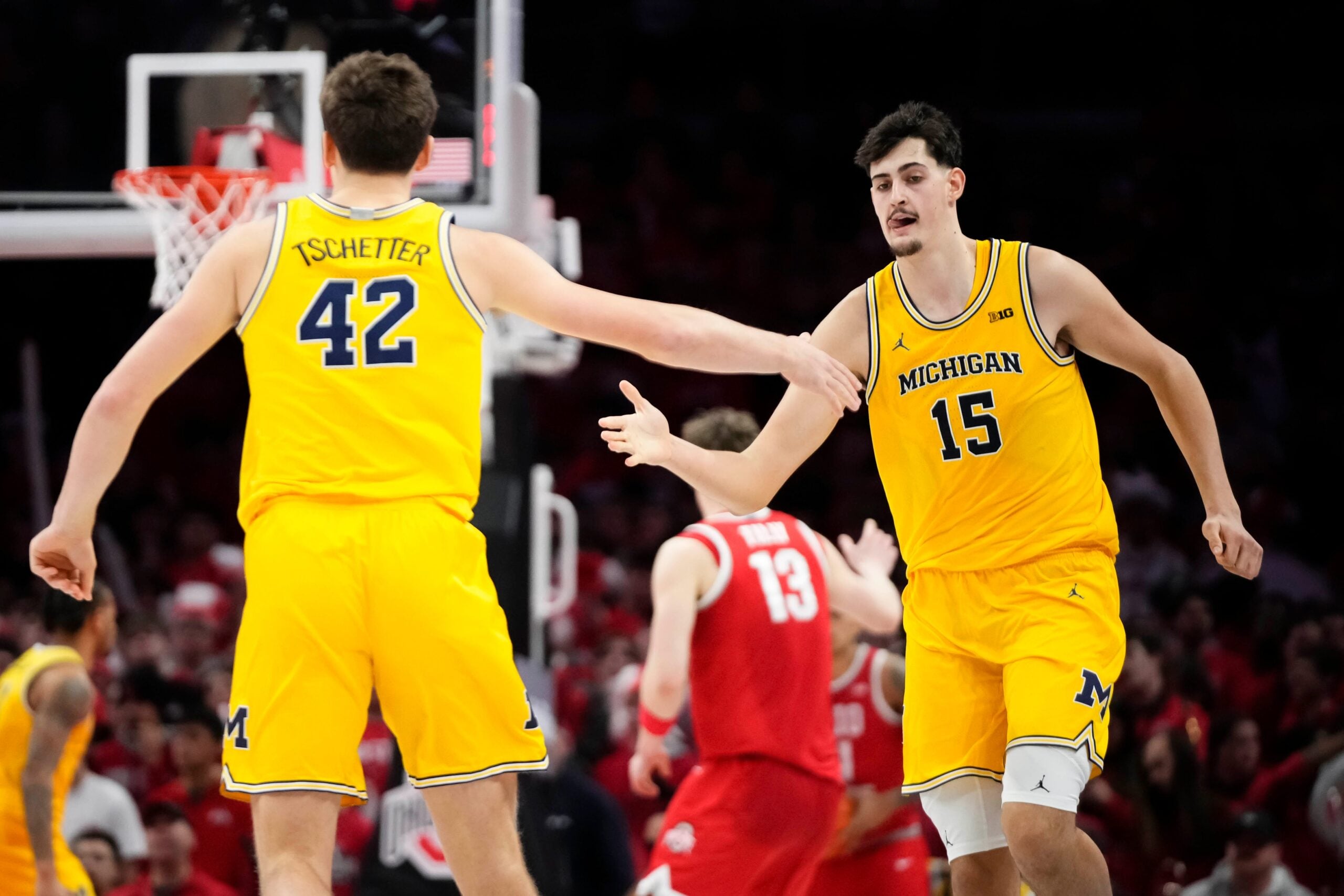 Michigan Wolverines center Aday Mara (15) celebrates a shot with forward Will Tschetter (42) during the second half of the NCAA men's basketball game against the Ohio State Buckeyes at the Schottenstein Center in Columbus on Feb. 8, 2026. Ohio State lost 82-61.
