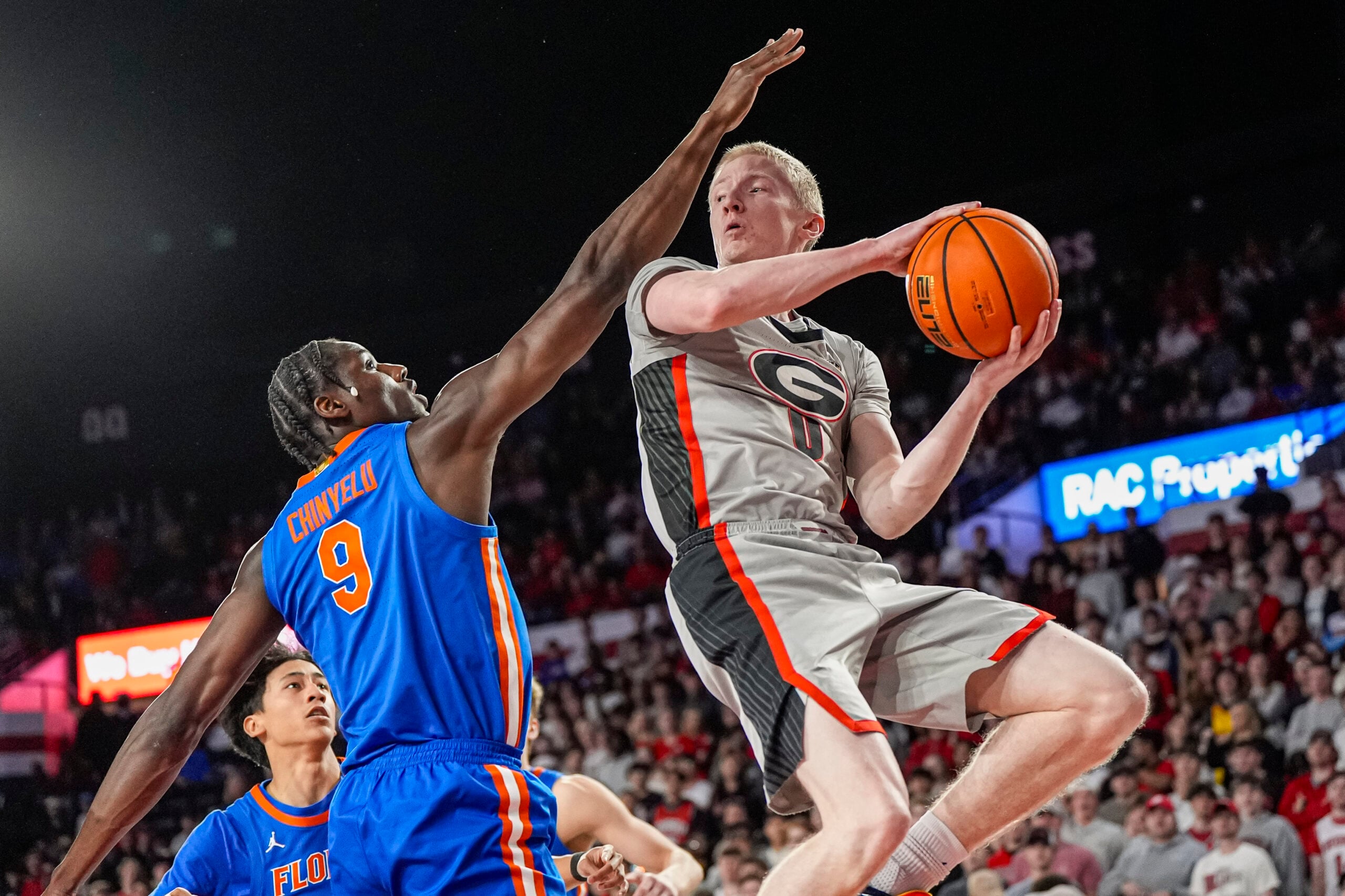Feb 11, 2026; Athens, Georgia, USA; Georgia Bulldogs guard Blue Cain (0) looks to pass against Florida Gators center Rueben Chinyelu (9) during the first half at Stegeman Coliseum. Mandatory Credit: Dale Zanine-Imagn Images