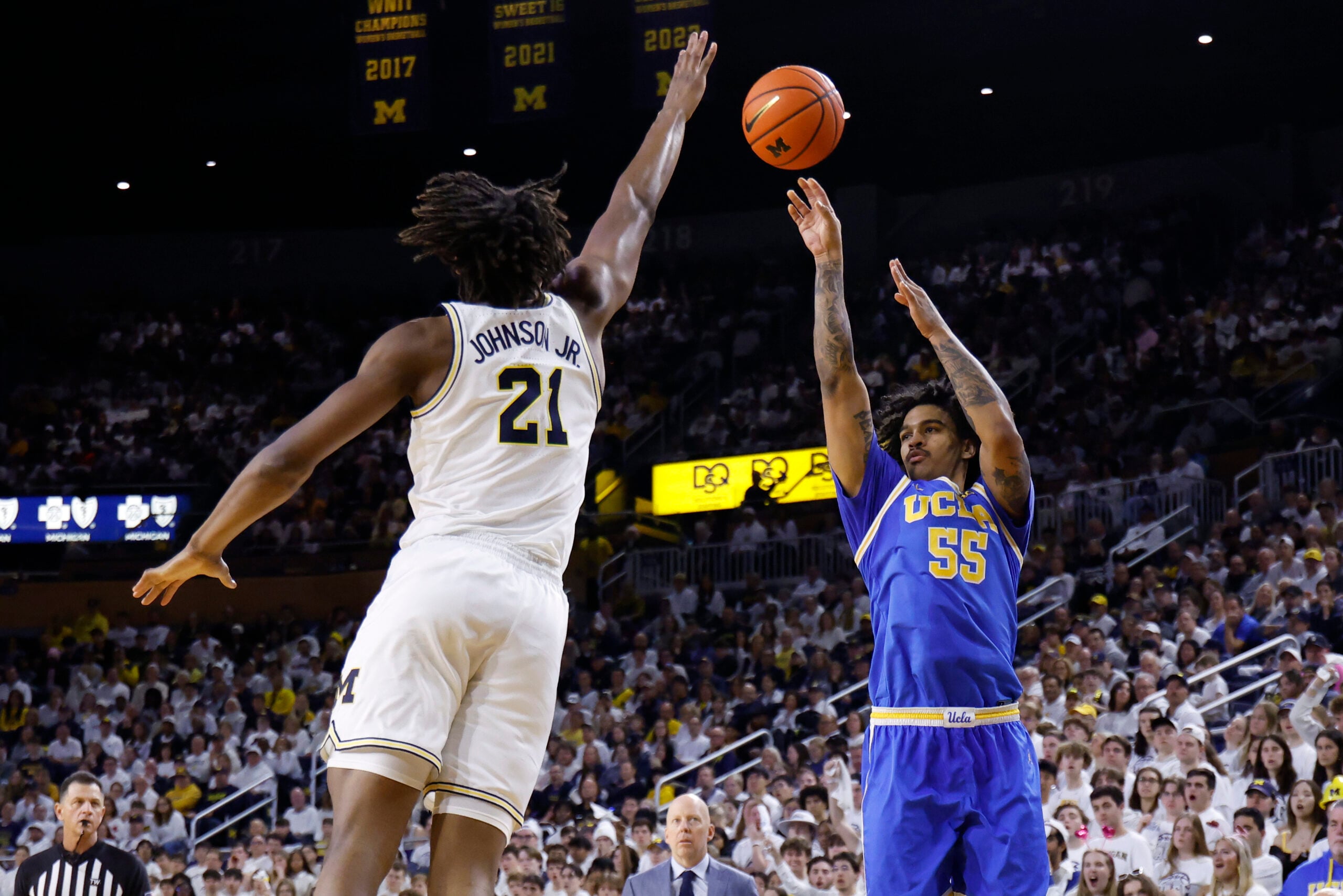 Feb 14, 2026; Ann Arbor, Michigan, USA; UCLA Bruins guard Skyy Clark (55) shoots on Michigan Wolverines forward Morez Johnson Jr. (21) in the second half at Crisler Center. Mandatory Credit: Rick Osentoski-Imagn Images