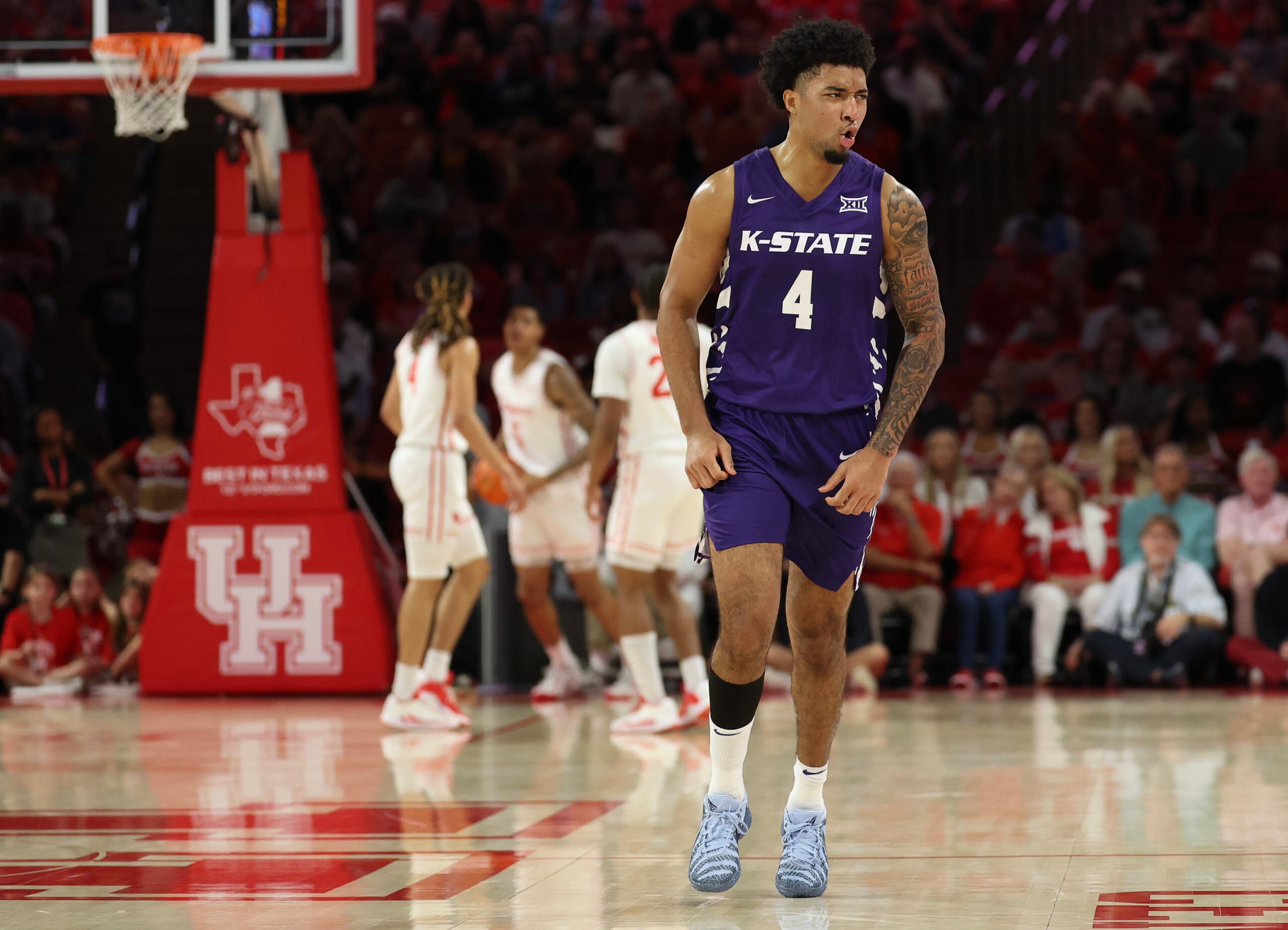 Feb 14, 2026; Houston, Texas, USA; Kansas State Wildcats guard PJ Haggerty (4) celebrates his three point basket against the Houston Cougars in the first half at Fertitta Center. Mandatory Credit: Thomas Shea-Imagn Images