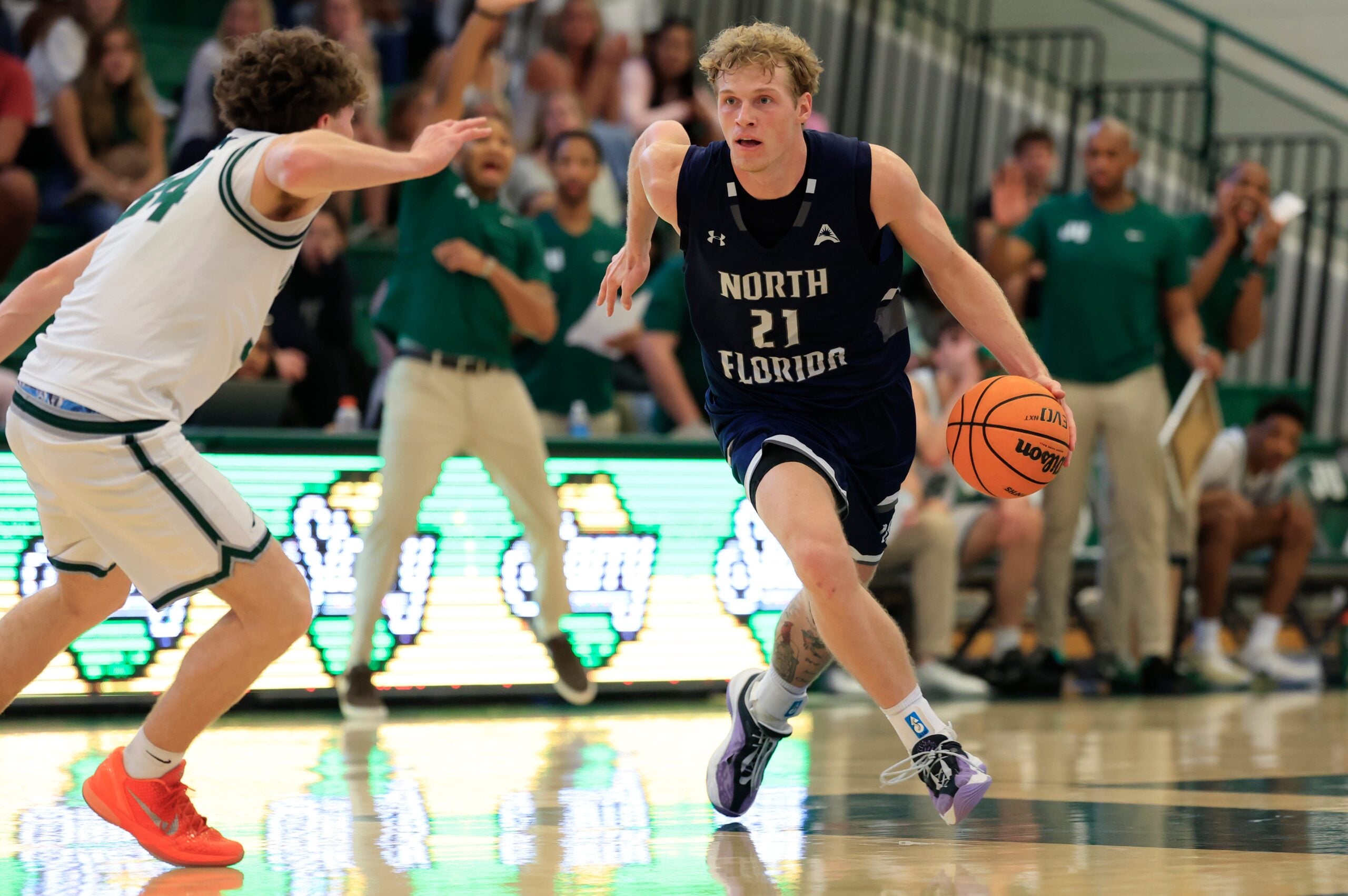 North Florida Ospreys forward Dalton Gayman (21) defends against Jacksonville Dolphins guard Evan Sterck (34) during the second half of an NCAA men’s basketball game at Swisher Gymnasium, Saturday, Feb. 14, 2026, in Jacksonville, Fla. JU held off UNF 63-56. [Corey Perrine/Florida Times-Union]