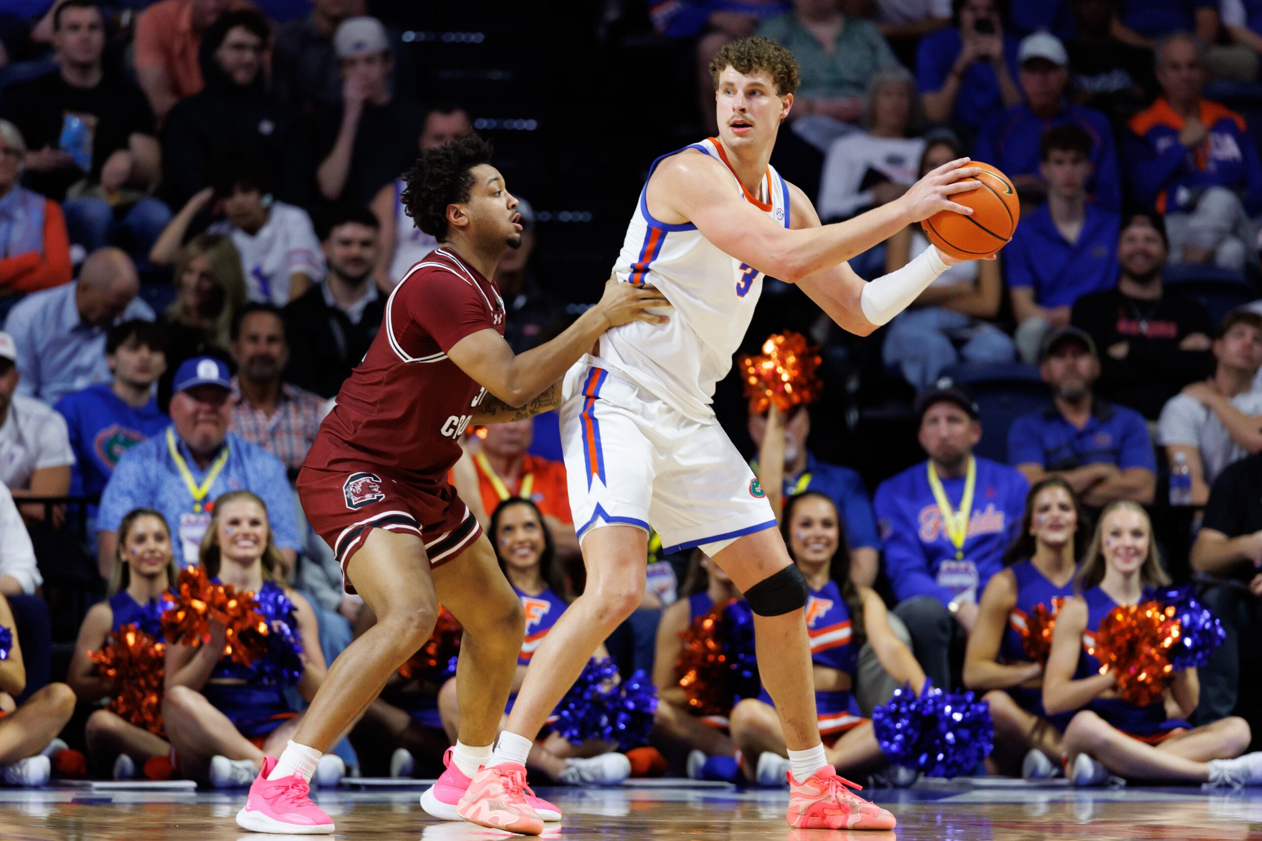 Feb 17, 2026; Gainesville, Florida, USA; Florida Gators center Micah Handlogten (3) posts up against South Carolina Gamecocks forward Elijah Strong (31) during the first half at Exactech Arena at the Stephen C. O'Connell Center. Mandatory Credit: Matt Pendleton-Imagn Images