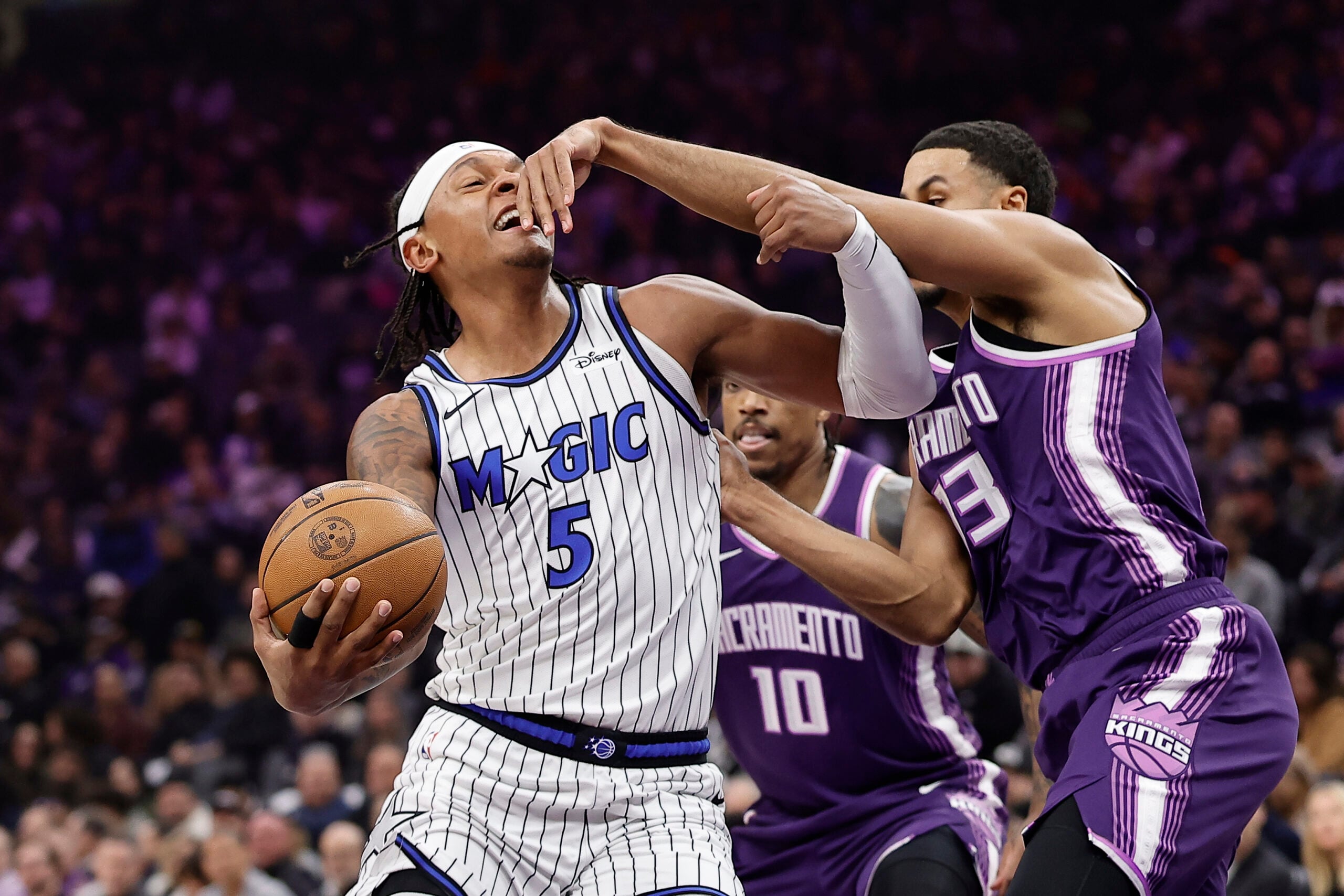 Feb 19, 2026; Sacramento, California, USA; Orlando Magic forward Paolo Banchero (5) drives in against Sacramento Kings forward Keegan Murray (13) during the first quarter at Golden 1 Center. Mandatory Credit: Kelley L Cox-Imagn Images