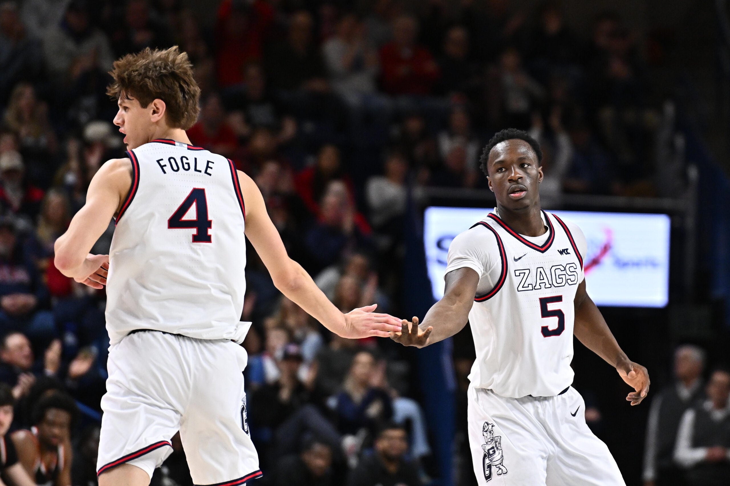 Feb 21, 2026; Spokane, Washington, USA; Gonzaga Bulldogs forward Emmanuel Innocenti (5) and Gonzaga Bulldogs guard Davis Fogle (4) high five during a game against the Pacific Tigers in the second half at McCarthey Athletic Center. Gonzaga Bulldogs won 71-62. Mandatory Credit: James Snook-Imagn Images