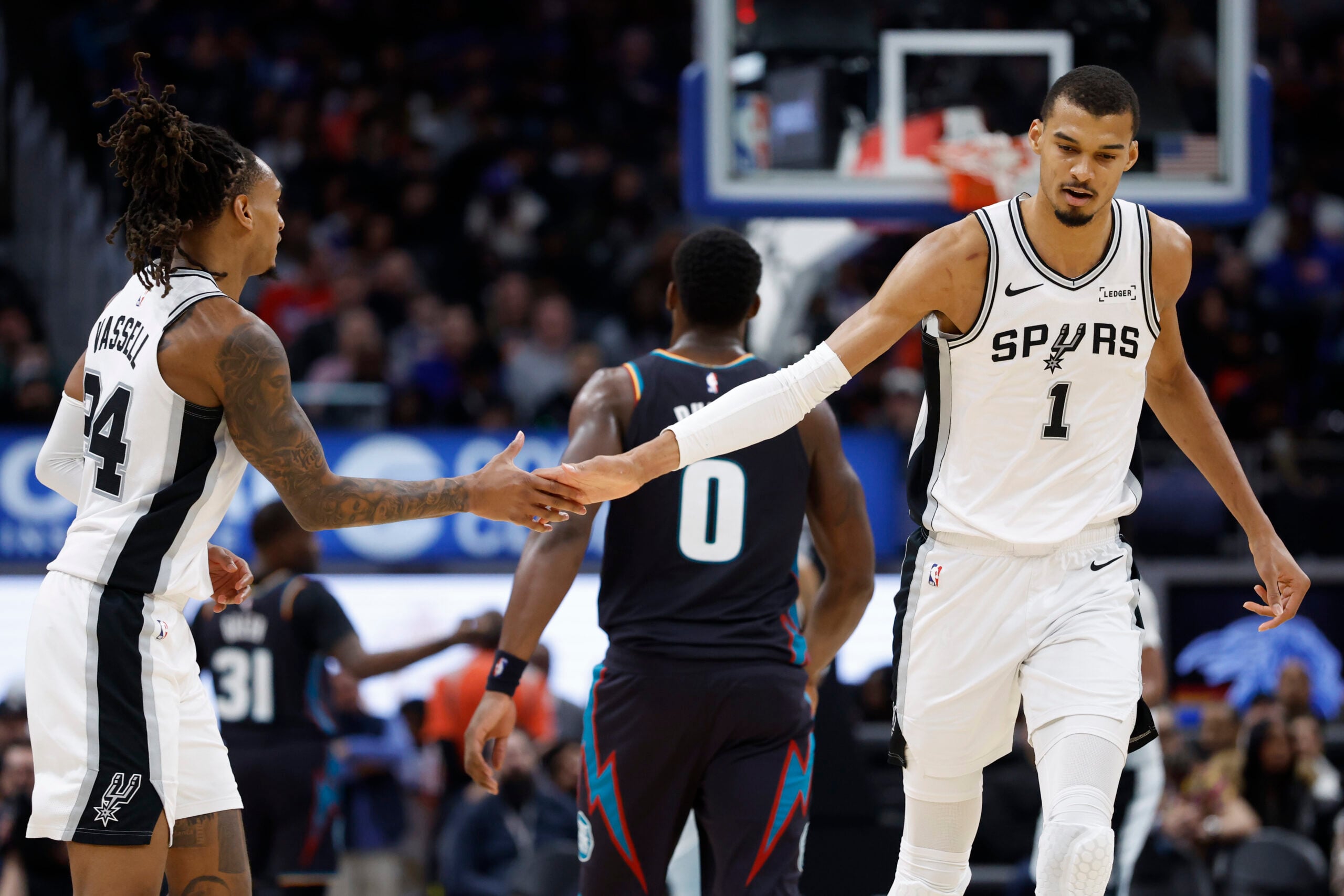 Feb 23, 2026; Detroit, Michigan, USA;  San Antonio Spurs forward Victor Wembanyama (1) receives congratulations from guard Devin Vassell (24) in the second half against the Detroit Pistons at Little Caesars Arena. Mandatory Credit: Rick Osentoski-Imagn Images