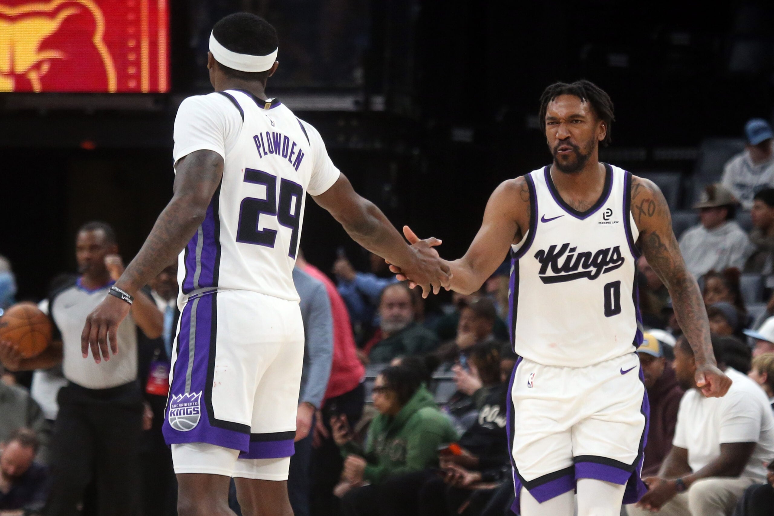 Feb 23, 2026; Memphis, Tennessee, USA; Sacramento Kings guard Malik Monk (0) reacts with guard Daeqwon Plowden (29) during the fourth quarter against the Memphis Grizzlies at FedExForum. Mandatory Credit: Petre Thomas-Imagn Images