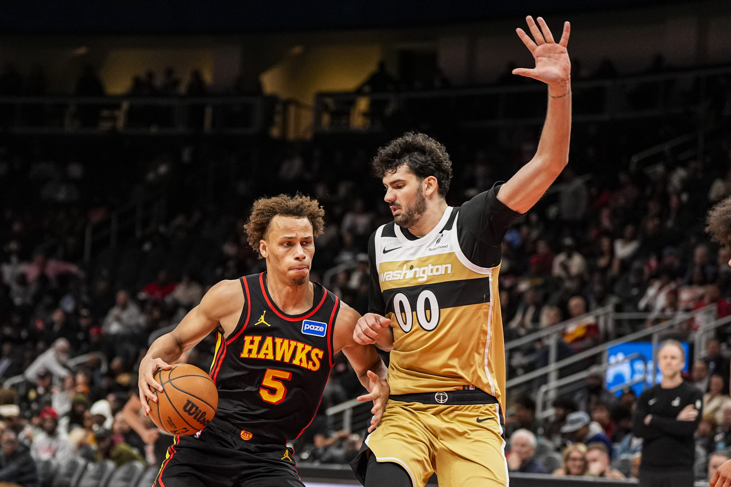 Feb 24, 2026; Atlanta, Georgia, USA; Atlanta Hawks guard Dyson Daniels (5) dribbles against Washington Wizards forward Tristan Vukcevic (00) during the second half at State Farm Arena. Mandatory Credit: Dale Zanine-Imagn Images