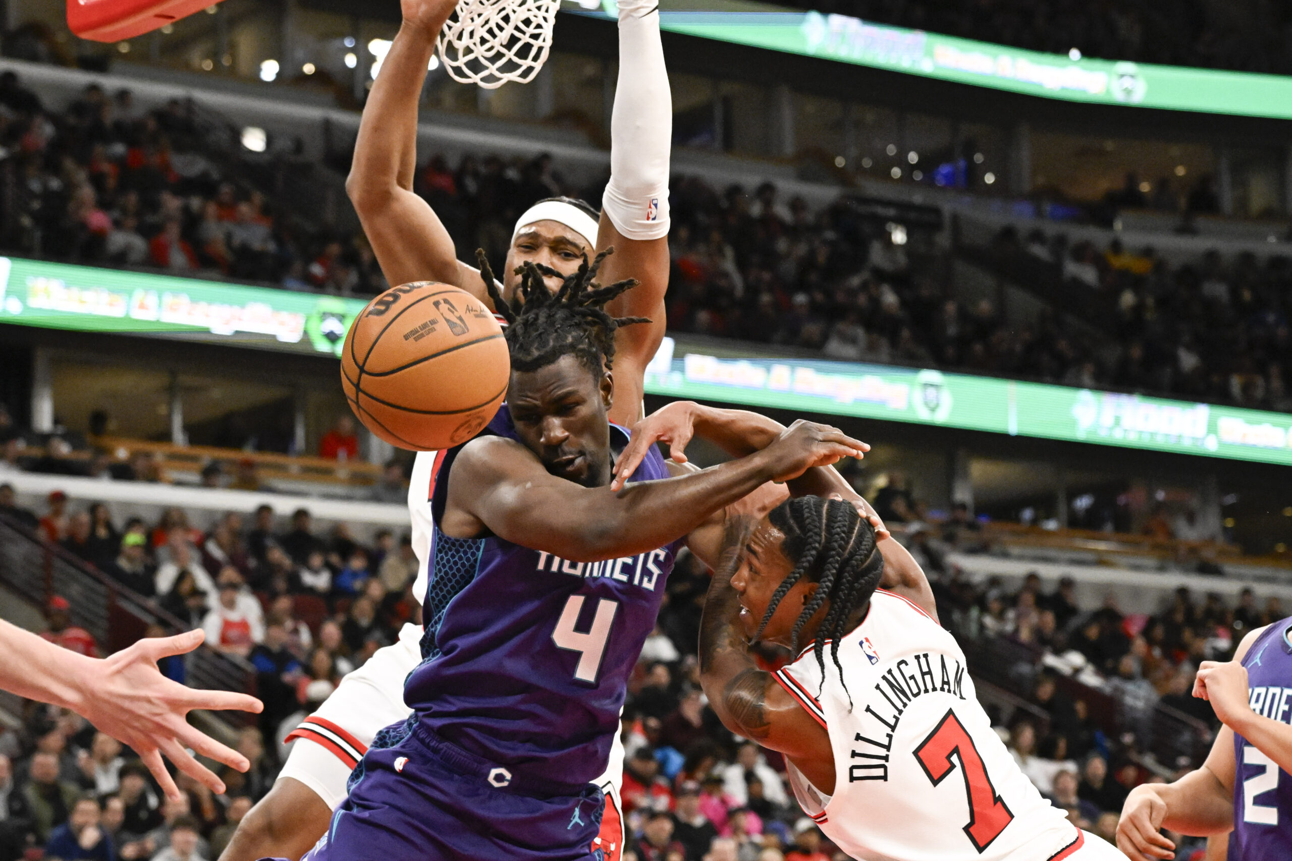 Feb 24, 2026; Chicago, Illinois, USA; Charlotte Hornets guard Sion James (4) fights for the ball against Chicago Bulls forward Guerschon Yabusele (28) and guard Rob Dillingham (7) during the second half at United Center. Mandatory Credit: Matt Marton-Imagn Images