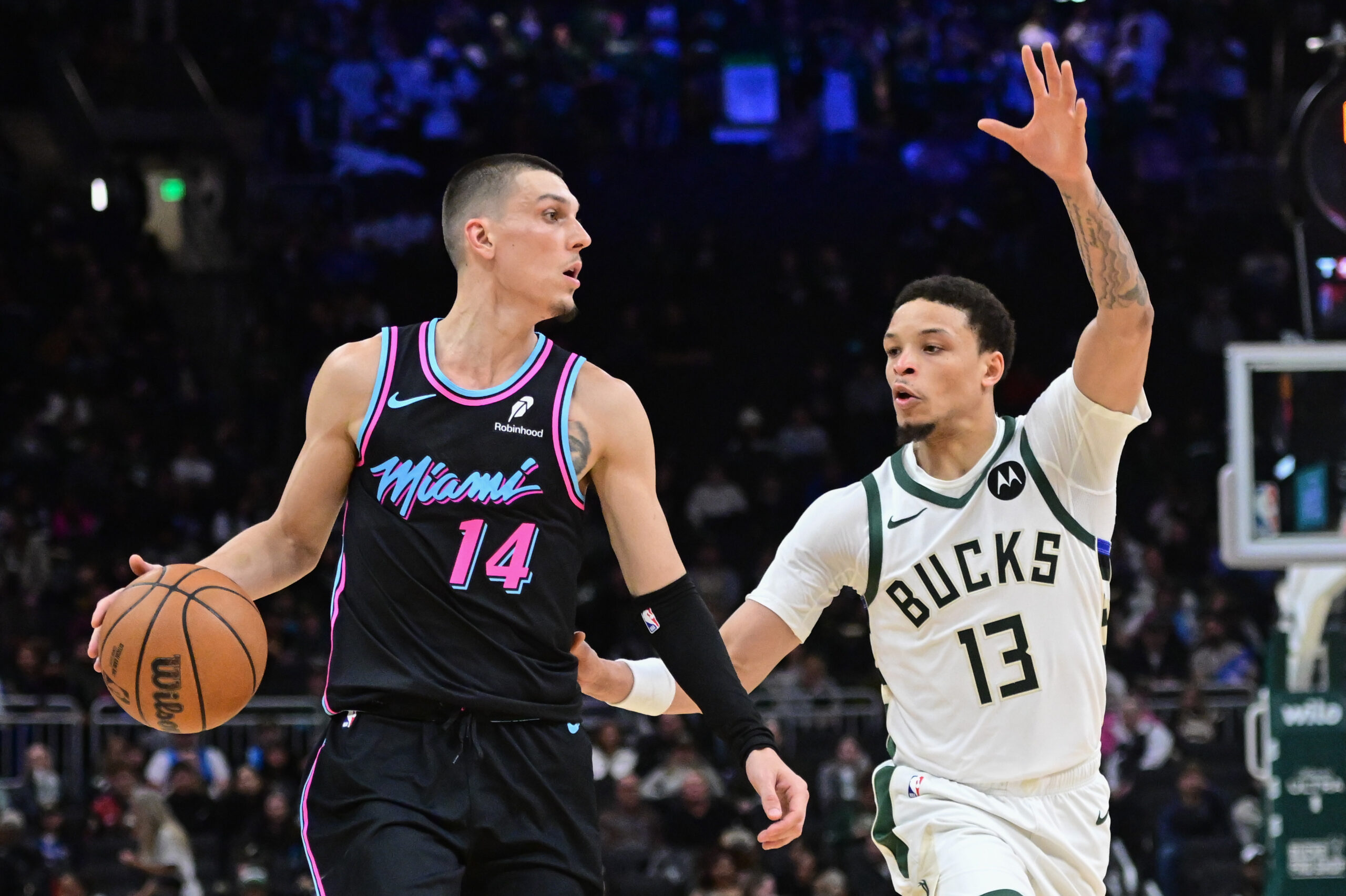 Feb 24, 2026; Milwaukee, Wisconsin, USA; Miami Heat guard Tyler Herro (14) looks for a shot against Milwaukee Bucks guard Ryan Rollins (13) in the fourth quarter at Fiserv Forum. Mandatory Credit: Benny Sieu-Imagn Images