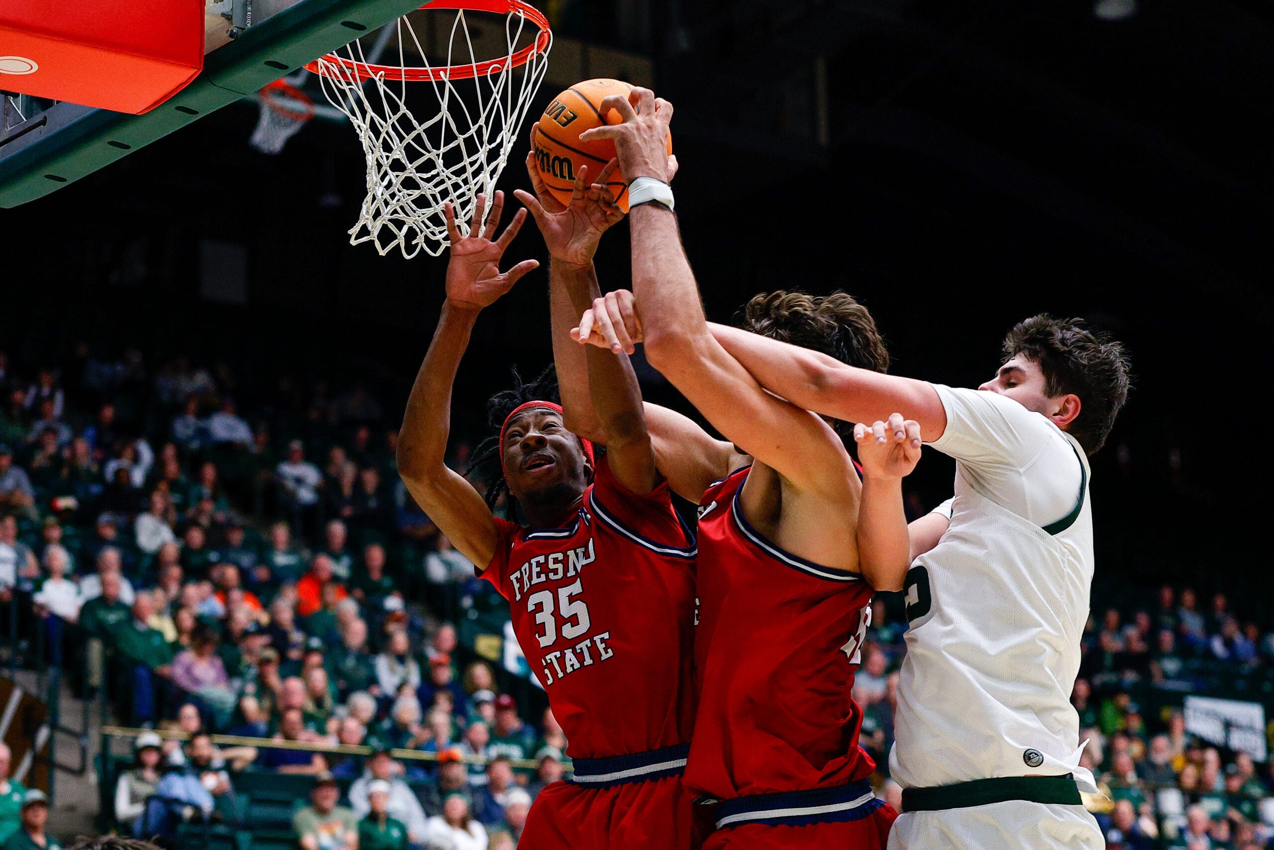 Feb 24, 2026; Fort Collins, Colorado, USA; Fresno State Bulldogs center Wilson Jacques (16) battles for a rebound with Colorado State Rams forward Kyle Jorgensen (35) and forward Deshawn Gory (35) in the second half at Moby Arena. Mandatory Credit: Isaiah J. Downing-Imagn Images