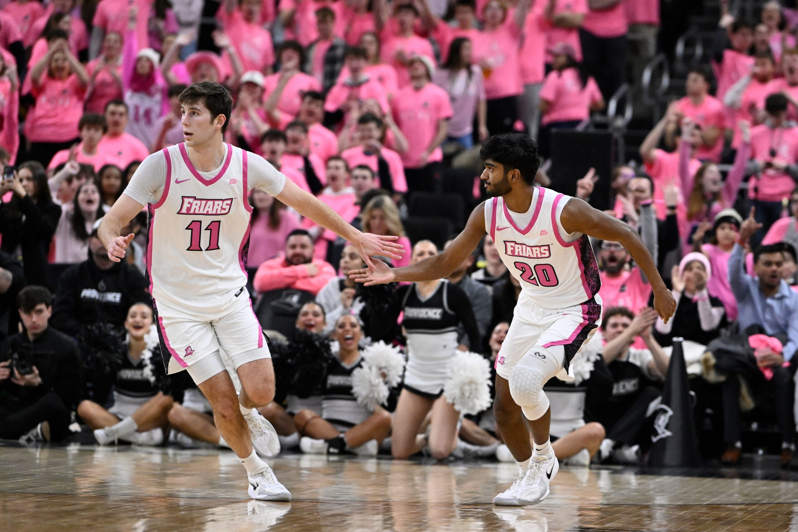 Feb 25, 2026; Providence, Rhode Island, USA; Providence Friars guard Nilavan Daniels (20) celebrates a basket against the Xavier Musketeers with guard Ryan Mela (11) during the second half at Amica Mutual Pavilion. Mandatory Credit: Eric Canha-Imagn Images